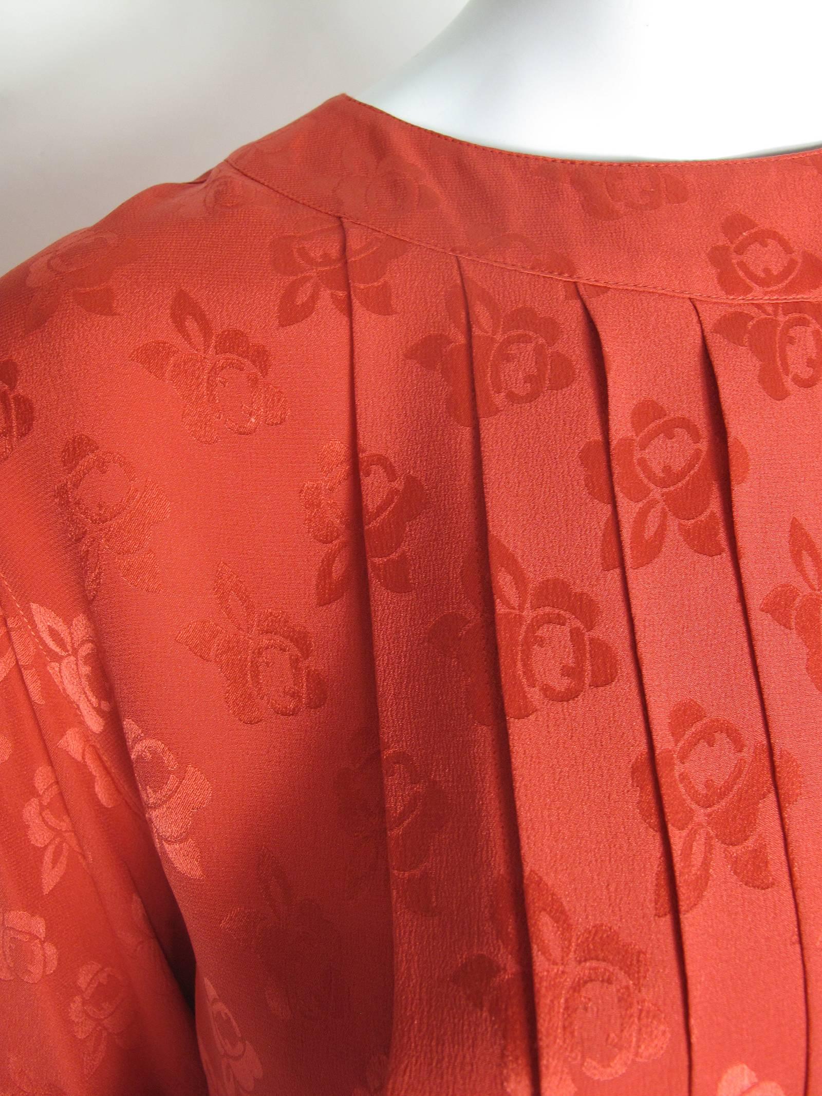Fendi red silk blouse with pleating.  Condition: Excellent.  Size Medium
We accept returns for refund, please see our terms.  We offer free ground shipping within the US
