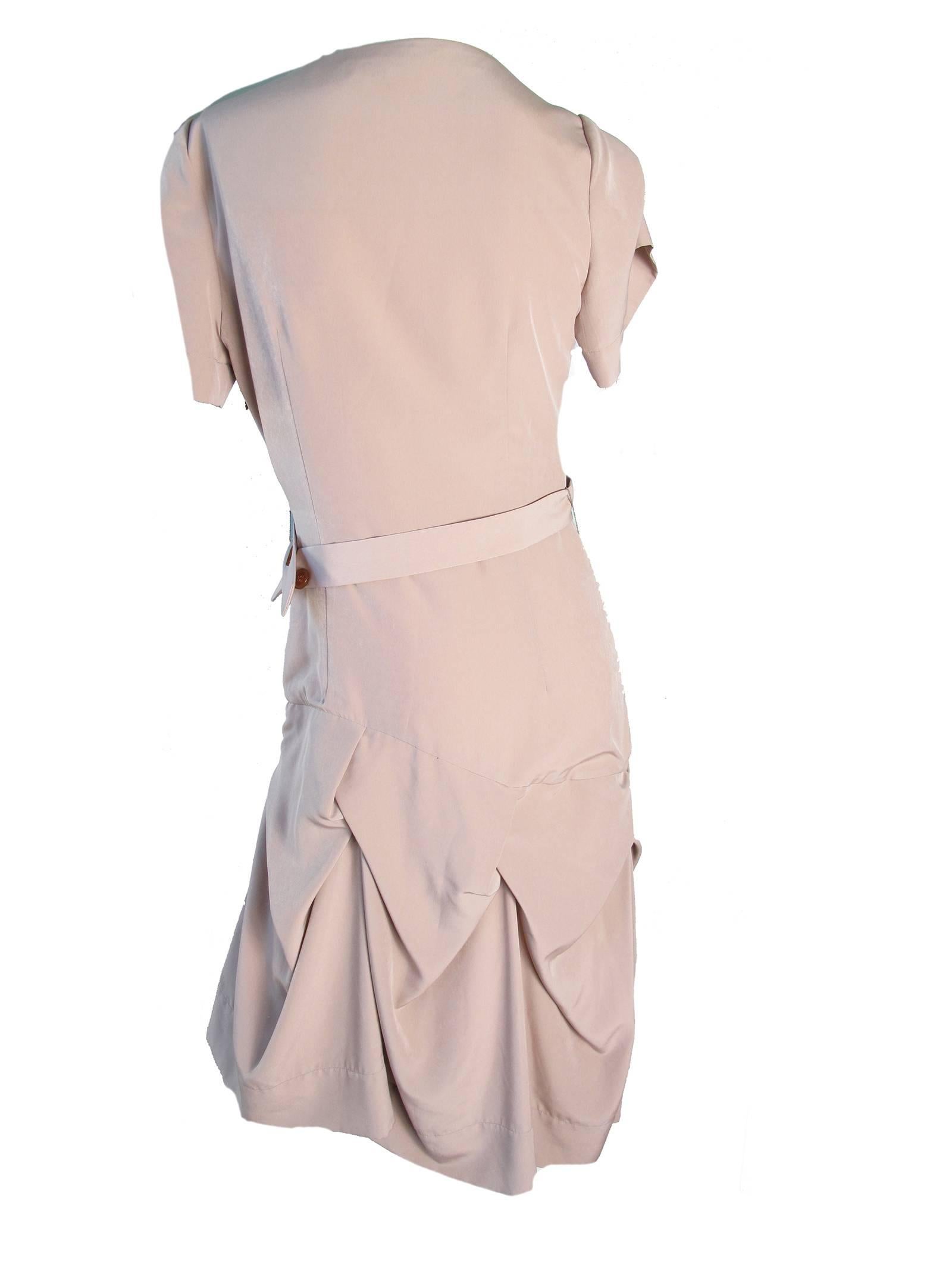 Vivienne Westwood red label mauve dress with interesting pleating at hem. polyester. Condition: good, discoloration on back right back. Size US 8
We accept returns for refund, please see our terms.  We offer free ground shipping within the US. 
