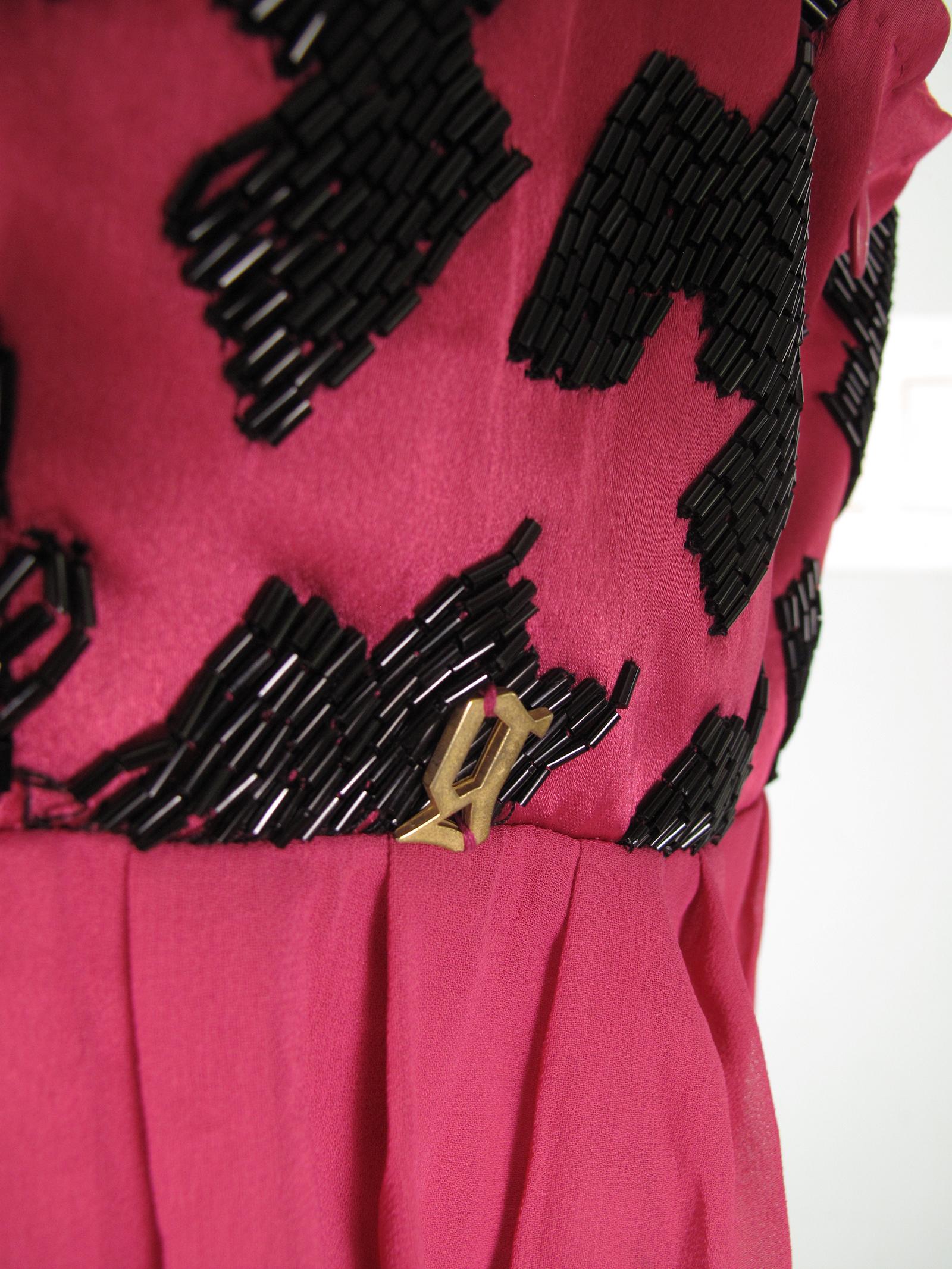 John Galliano fuchsia silk dress with black beading.  Condition: Good, some beads missing, see photos.  Size 44

We accept returns for refund, please see our terms.  We offer free ground shipping within the US.  