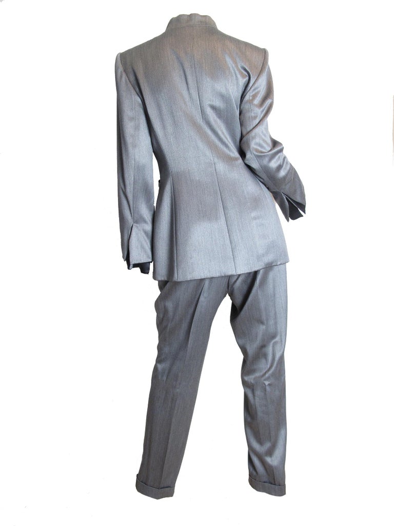 Christian Dior Boutique grey suit with large crystal buttons.  Condition: very good, one crystal button has wear underneath, see photos. Suit has not been worn. 

Size 42 / US 8 ( mannequin is US size 6 )

We accept returns for refund. We offer free