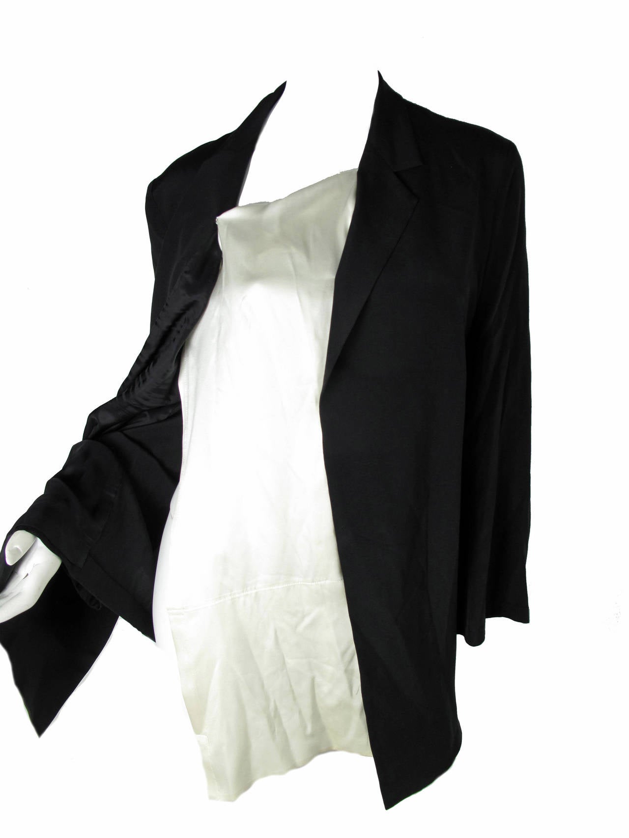 Gorgeous Yohji Yamamoto black silk blazer with asymmetrical cream silk fabric that snaps in place to look like a shirt.  Can be removed.  Size Large

38