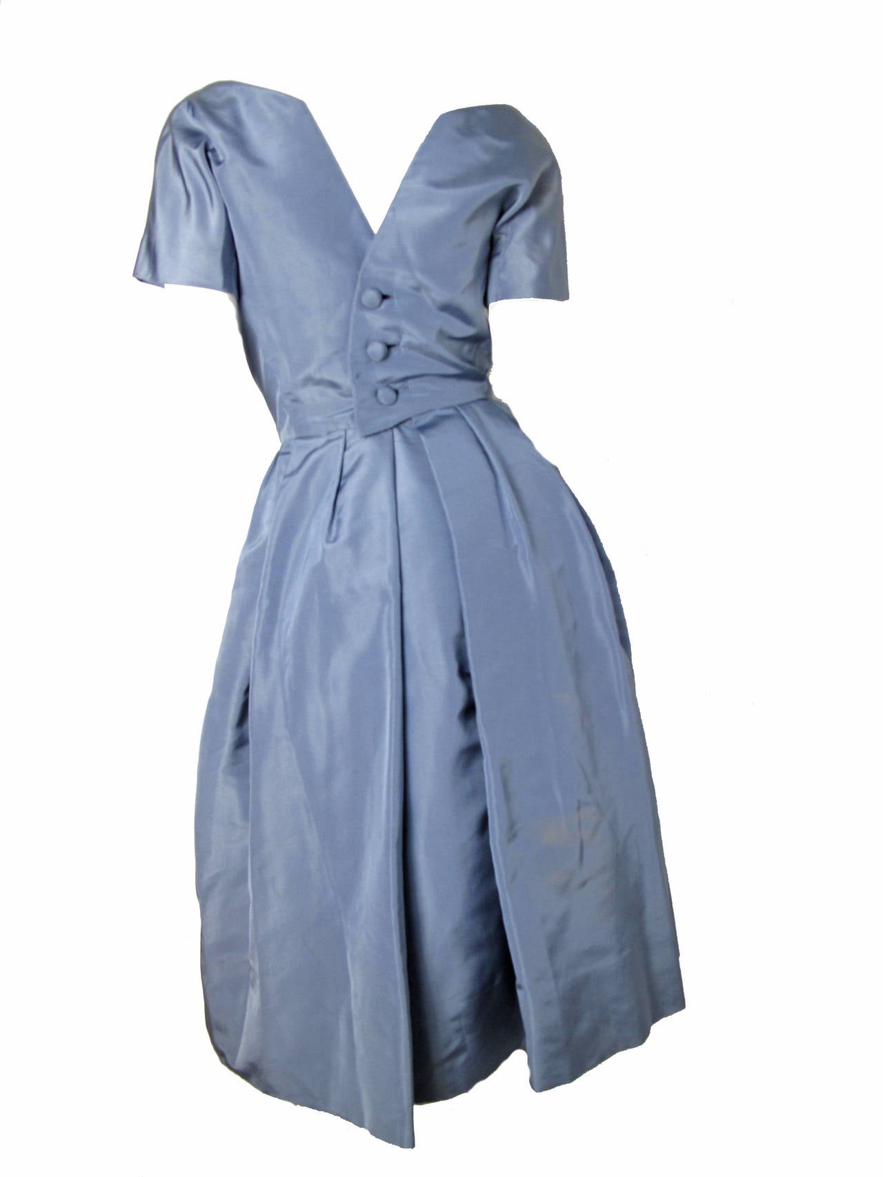 1950s Christian Dior blue taffeta dress with separate crinoline skirt. Condition: Fair, armholes have been repaired, some discoloration to silk, hem is coming undone and stitching is coming apart a seem at back- see photos.   

36" bust,
