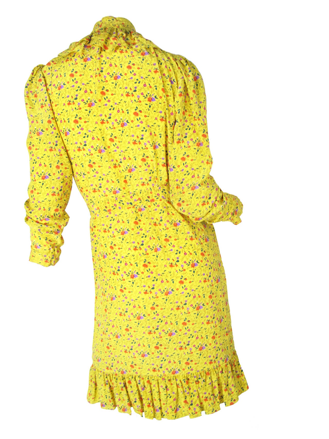 Ungaro yellow floral print silk peasant dress. Elastic at wrist. Two side pockets.  Removable belt for waist. Ties at collar. Ruffle at collar, cuffs and hem.  Condition: Excellent. Size 6

37