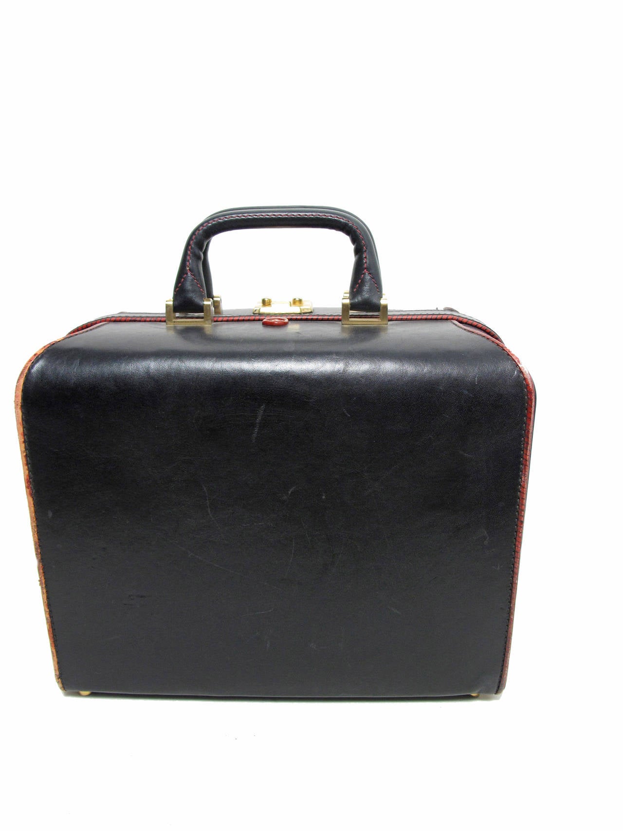 1970s black leather with red trim Valentino train case, with lock and key.  Stamped V on top to look like wax print.  Interior very good condition:  two separate compartments.  Wear to exterior, see photos. 12
