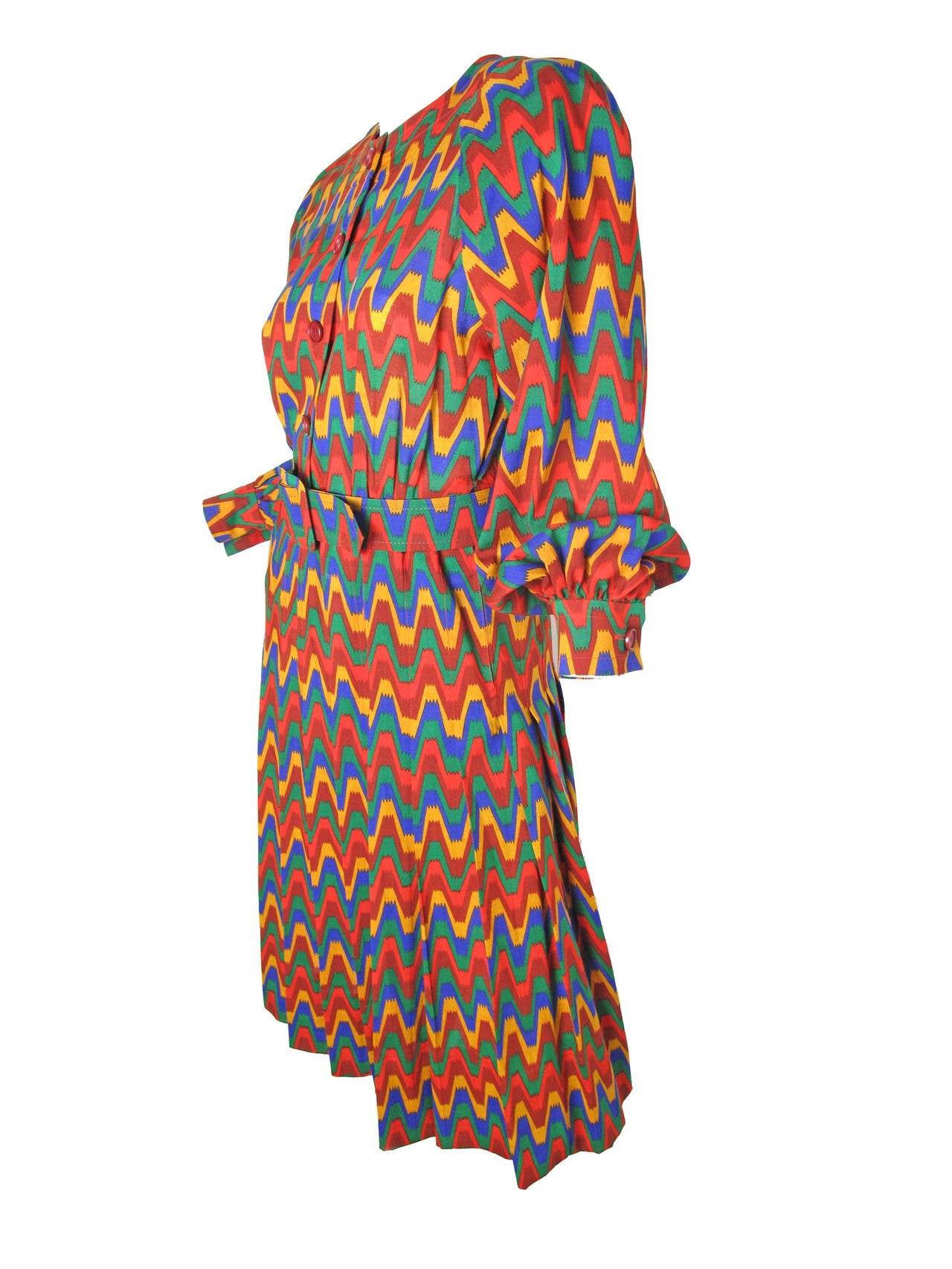1980s Givenchy multi-colored light wool dress - red, green, blue, yellow, green.  Buttons down front, removable belt, pleated from waist to hem. 
Condition: Very good, small hole has been repaired. 36