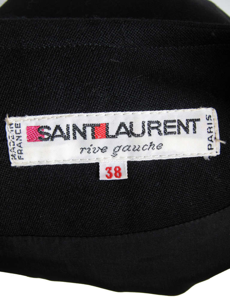 Yves Saint Laurent black wool dress with large buttons down front and side pockets.  38
