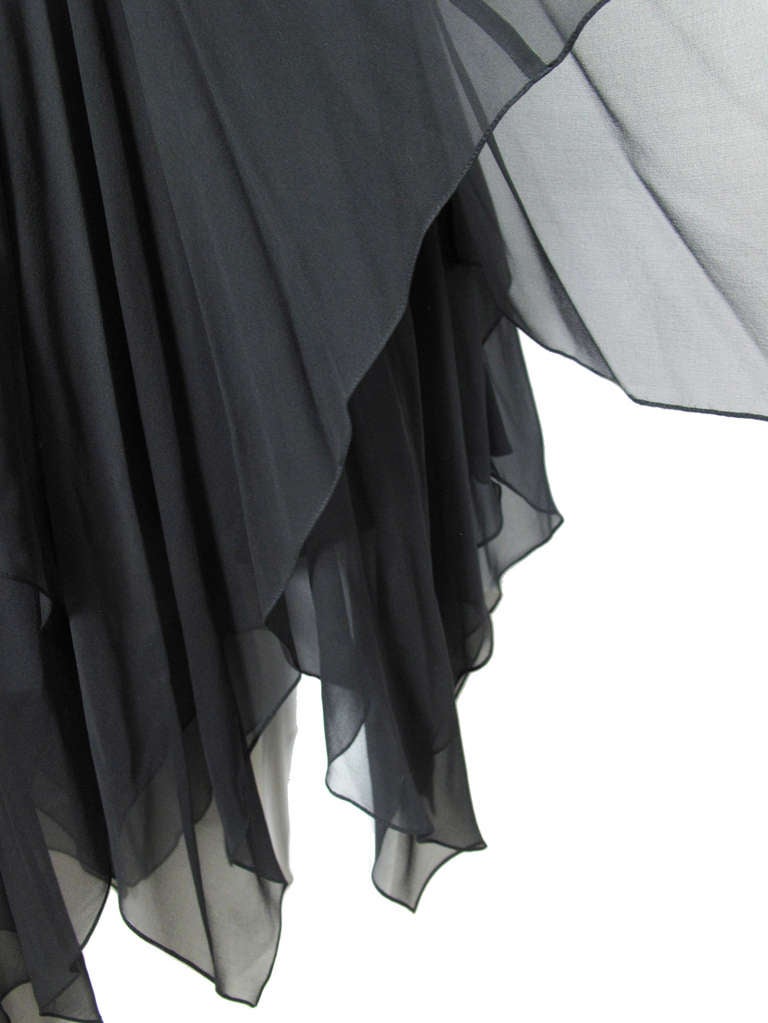 Oleg Cassini black sheer silk handkerchief skirt. Two layers of sheer fabric and one shorter lined layer underneath.  27" waist, 34 1/2" length. Condition: Excellent. Size 6