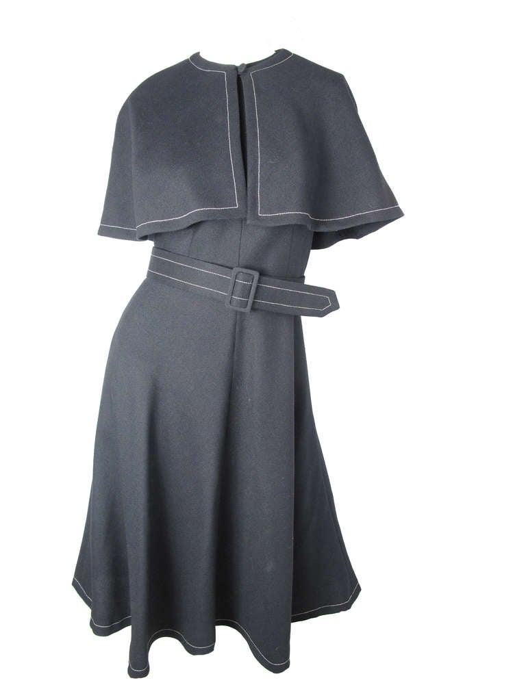 Mollie Parnis black linen dress with white stitching and criss cross back.  Removable belt and caplet. 35