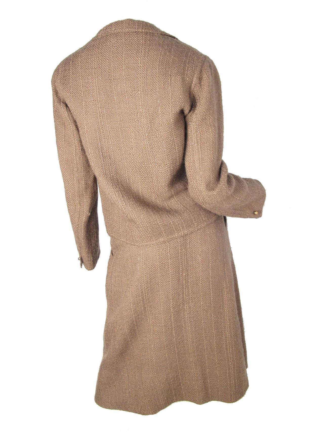 1970s Geoffrey Beene olive knit suit with gold thread intertwined.  Condition: Excellent. 
Skirt: 25