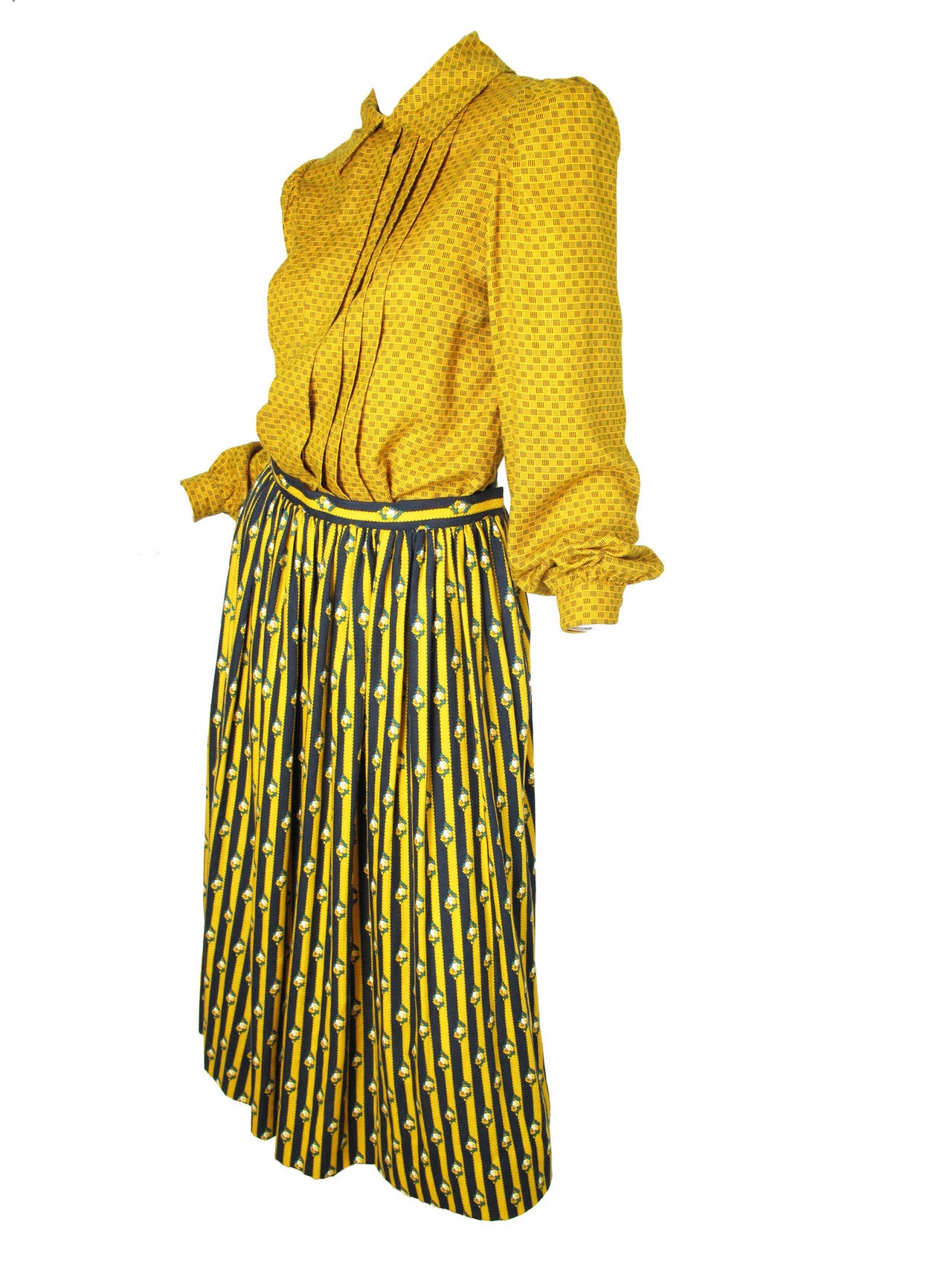 Oscar de la Renta mustard yellow wool printed blouse with tie. Yellow and navy floral / striped wool skirt. 

Top: 38