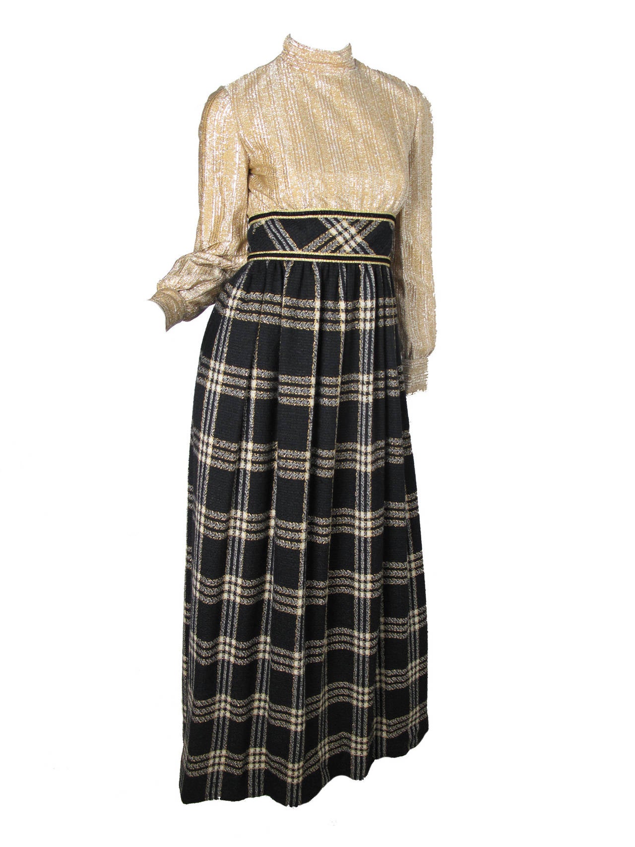 1970s Mollie Parnis Boutique wall plaid gown with gold lame bodice. With cropped herringbone jacket.   Condition: Very good, few pulls in lame. 

Size 4

Gown: 34
