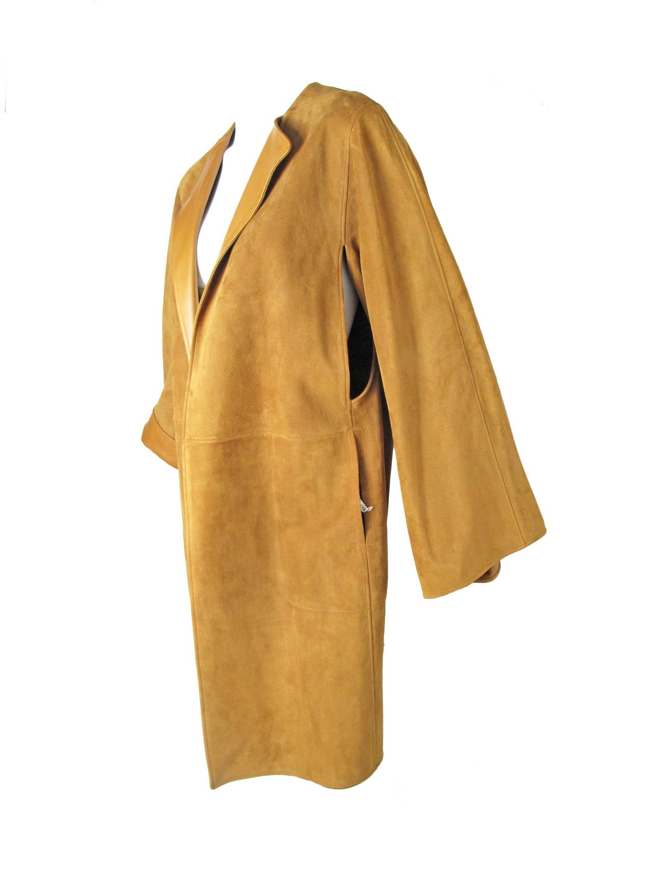 Rare Hermes camel lambskin suede coat.  Two side pockets, cuffs can be rolled up to show leather underneath.  Armholes are open and attach to drape across back. Not lined, just the beautiful leather underside shown.   Condition: Very good, shows