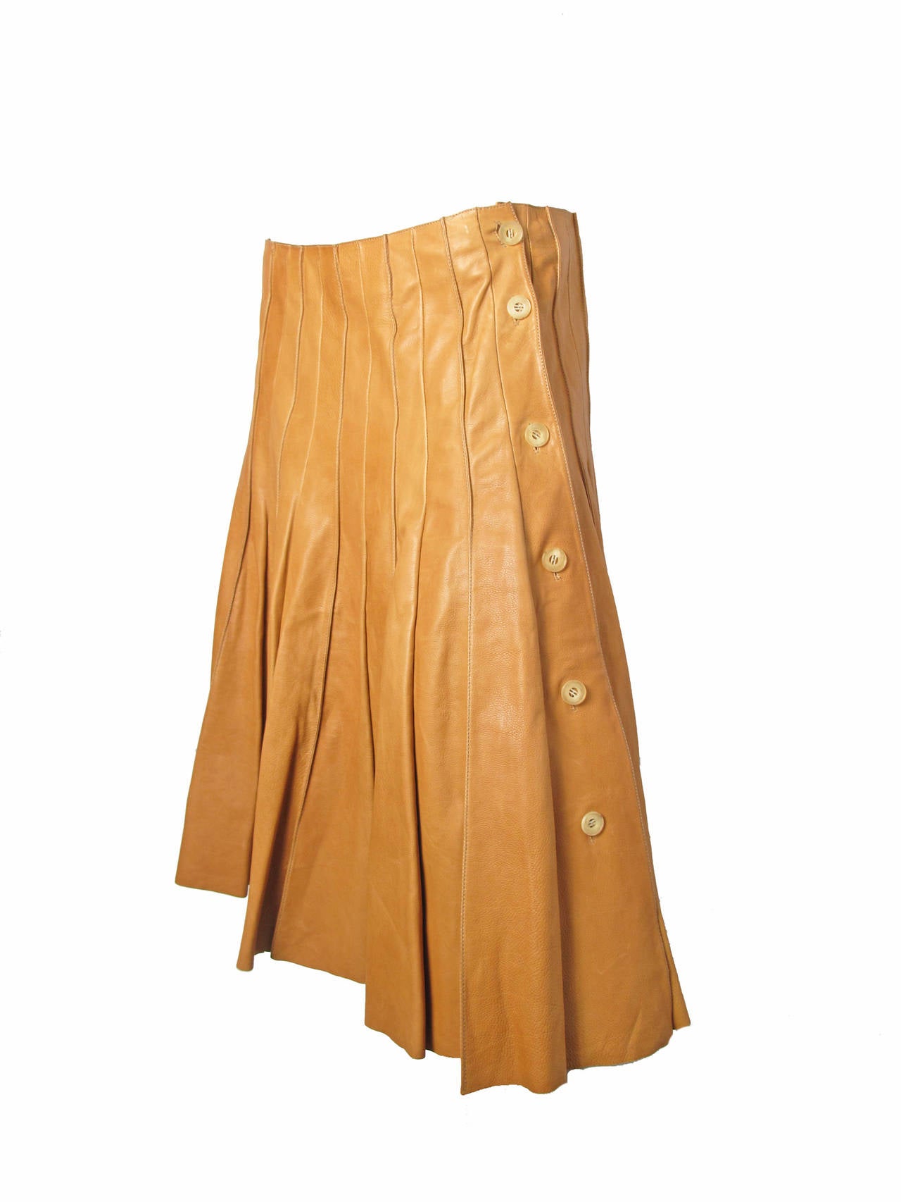Rare Hermes soft tan leather pleated skirt runway with buttons down side and raw edge at hem.  Lined with silk.   Created 2005 by Jean Paul Gaultier for Hermes.   

31