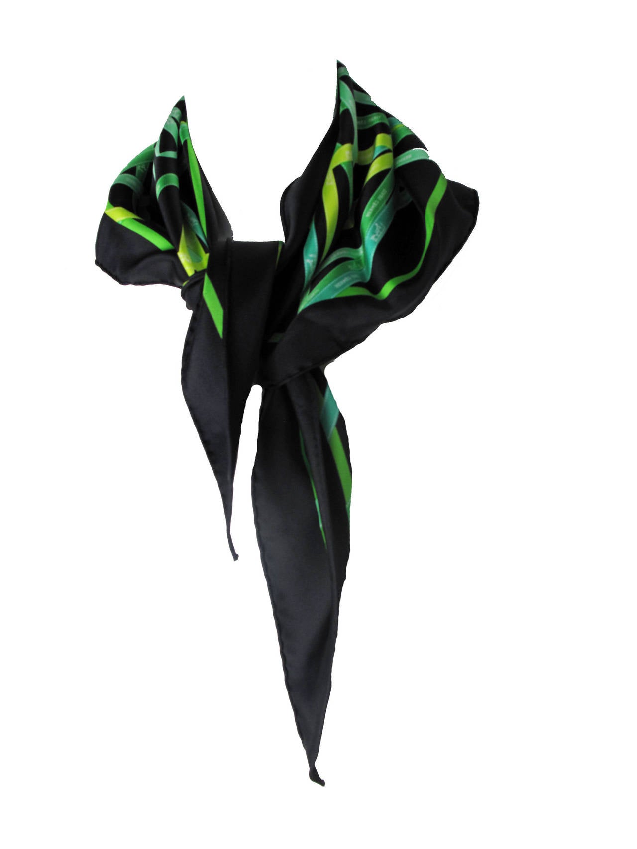 Hermes Bolduc ( hermes ribbon )  Print Black Silk Twill Triangle Scarf with Box. Black silk with green ribbon print.  Wonderfully modern color combination.

41.5