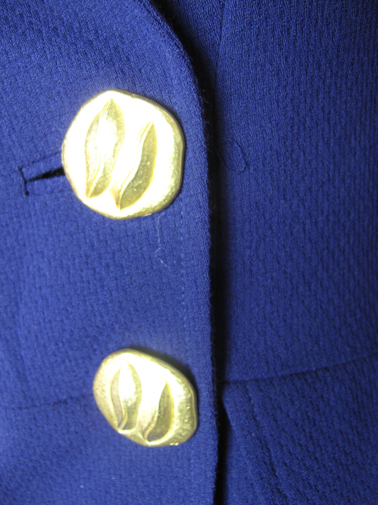 Christian Lacroix purple wool suit with gorgeous heavy metal buttons.  Two pockets on blazer hidden under peplum.  Two pockets in skirt. Condition: Excellent. 
Jacket: 35