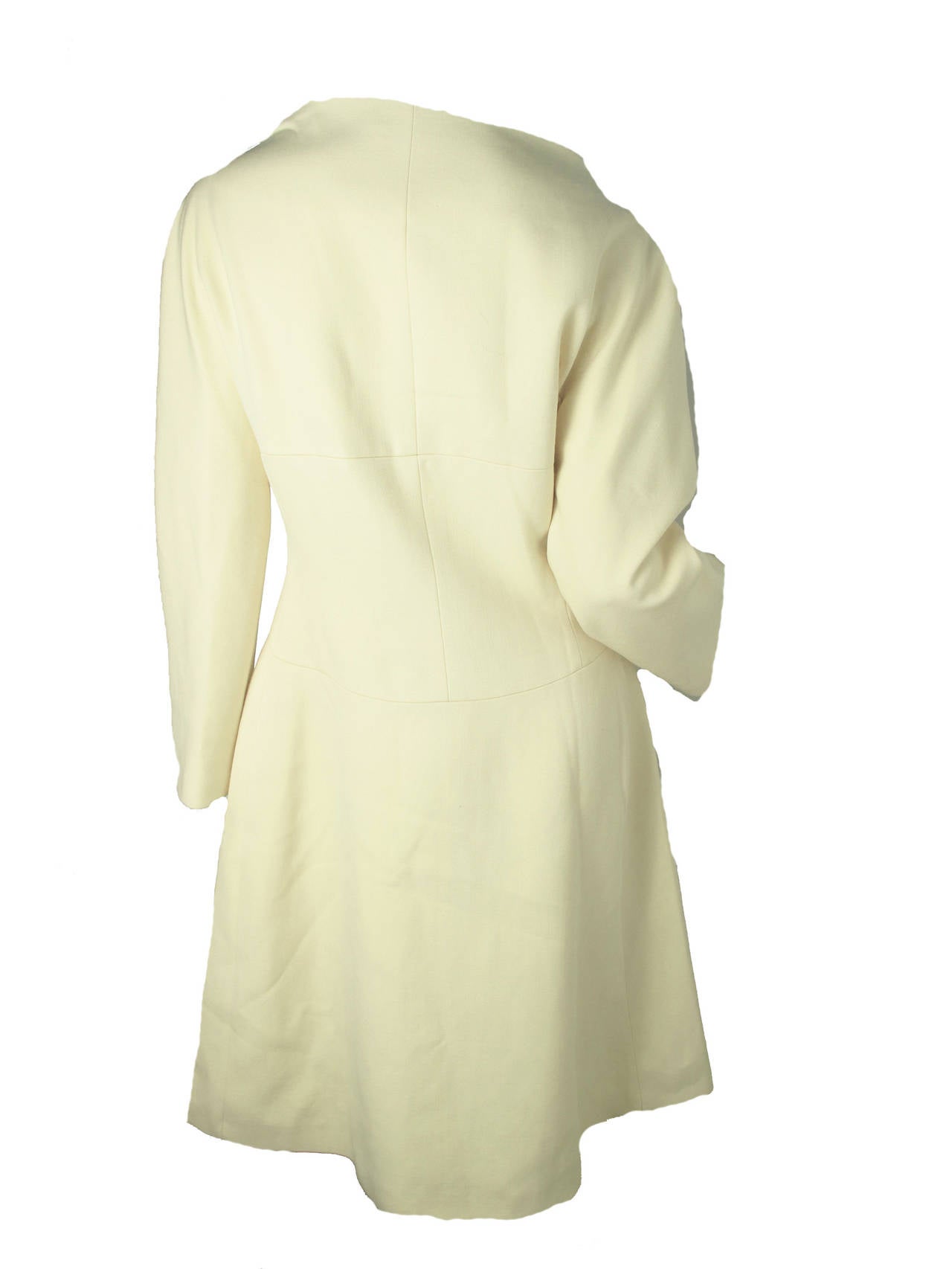 Ungaro cream wool coat with boat neck collar. Bright yellow silk lining. Snaps to close.  Condition: Good. 

Size 10 / US 6

38
