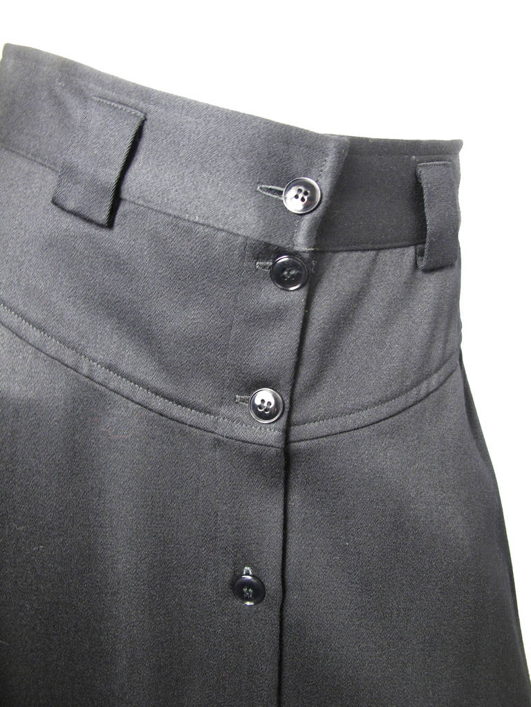 1980s Kenzo black wool long skirt with buttons down front and side pockets.  26