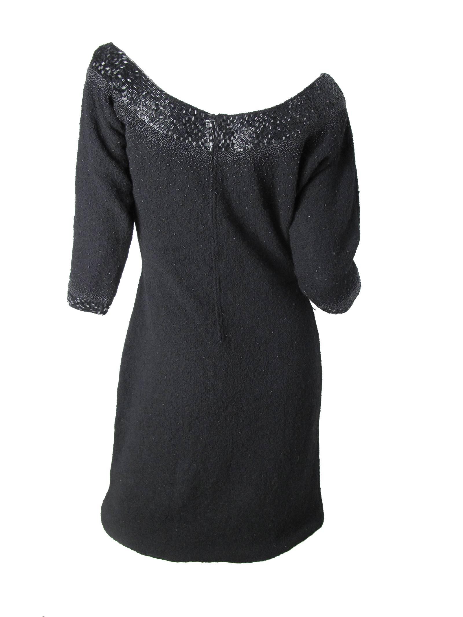 1960s Gene Shelly's Boutique Internationale black wool knit dress with black beading around cuffs and collar and smaller beading throughout garment. Partially lined in bust area.  Condition: Excellent Vintage Condition. 
Size 6 - 8

We accept