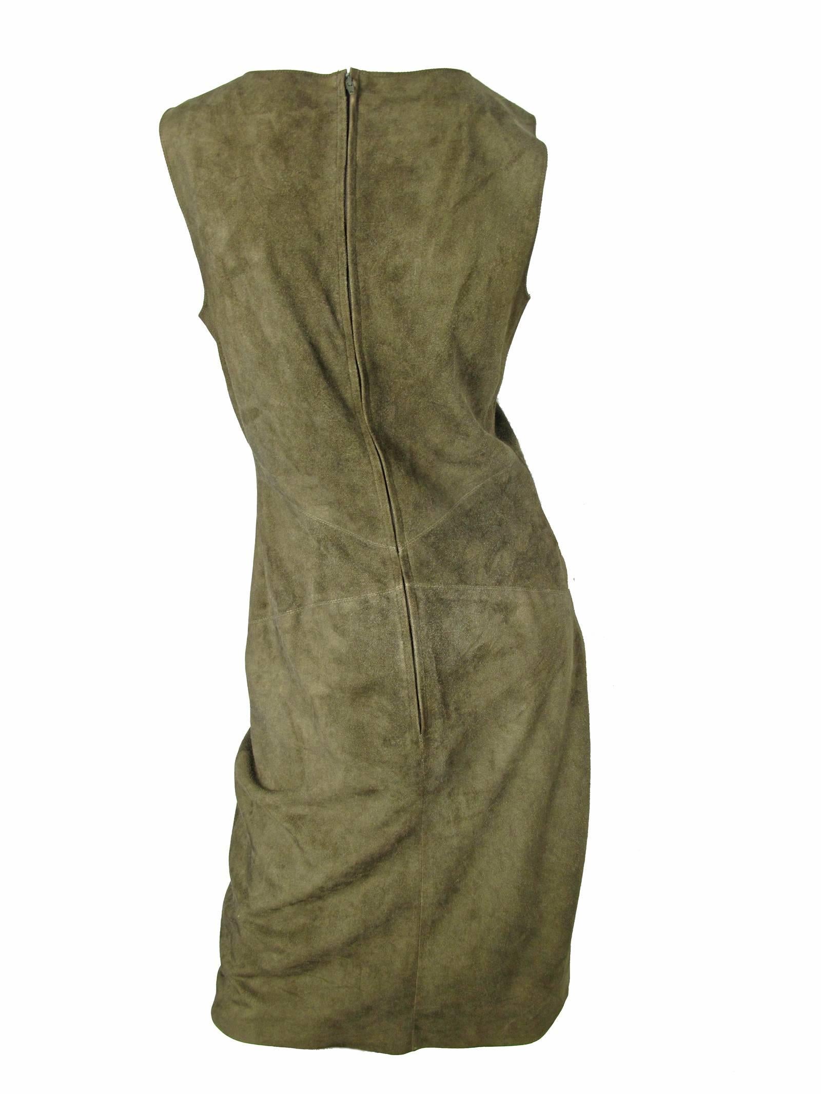 Fall 1999 green Chanel sleeveless soft suede (goatskin) dress with brass logo charm at front waist and back concealed zip closure. Lined the silk. Condition: Good, previously worn and shows all over wear.   Size 40 / US 8 - 10 ( mannequin is a size