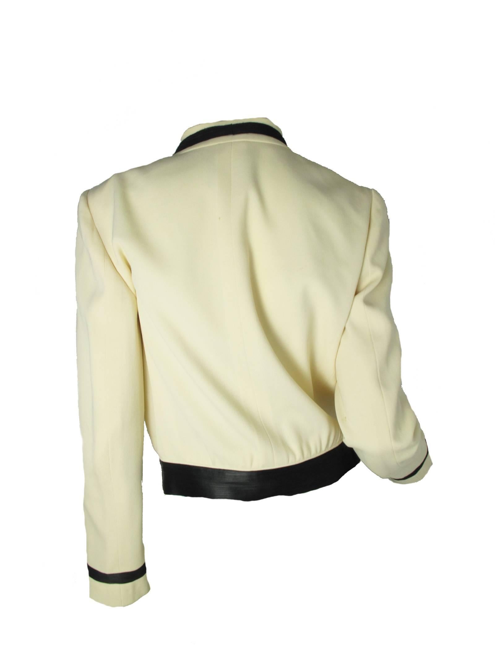 2002 Chanel jacket, cream wool gabardine, black ribbon trim, pearl and black buttons, military feel. Silk lined. Condition: Good, some underarm discoloration.   Made in France. Size 40/ US 8 

38" bust, 31" waist, 25 1/2" sleeve,15