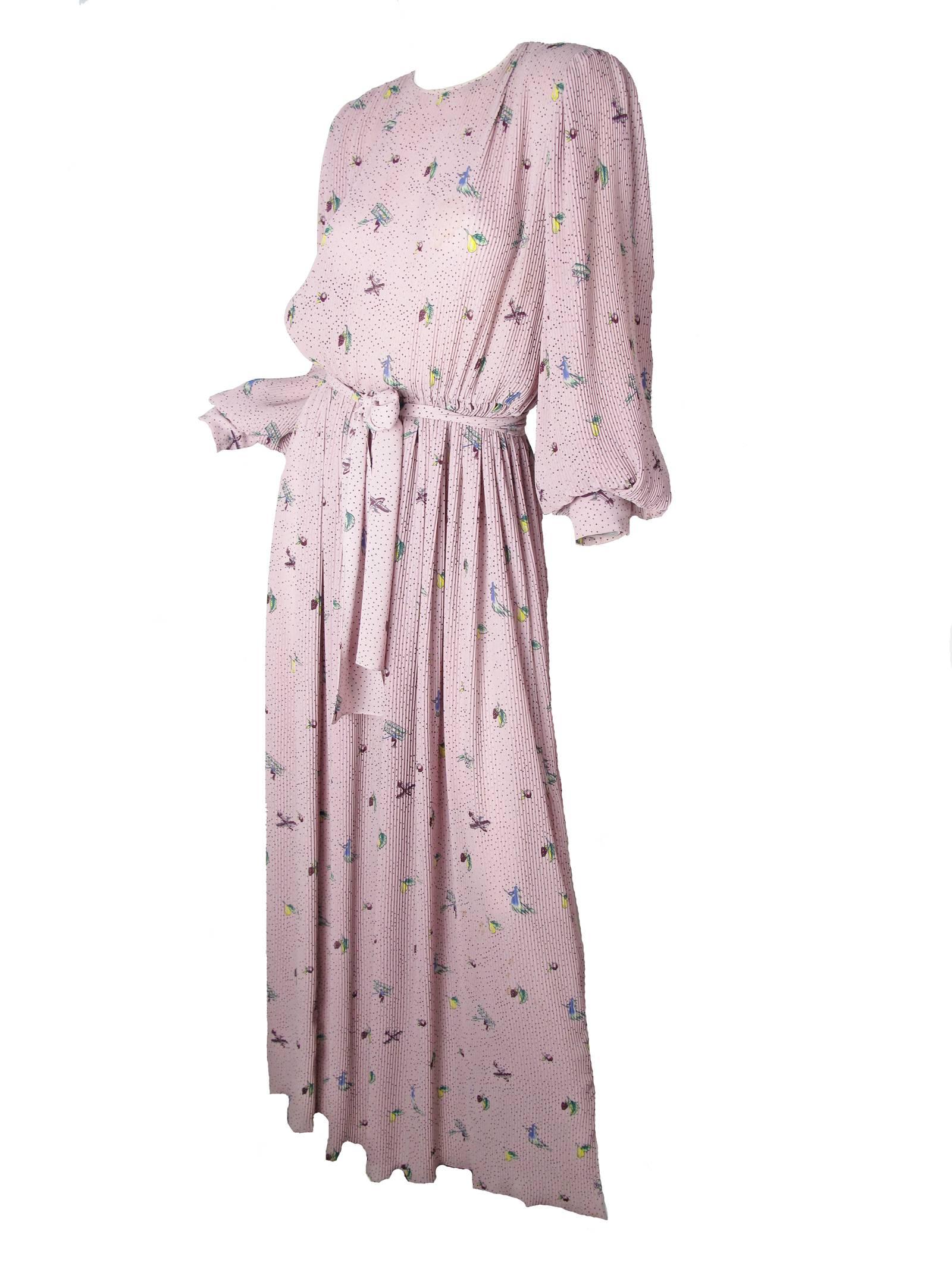 Hanae Mori dusty pink pleated gown with witch, fruit and airplane print.  Belt at waist, tie at neck, button cuffs.  Polyester fabric. Condition: Good, some faint spots on front.  Size 8 /10
42" bust, 25" elastic waist, 26 1/2"