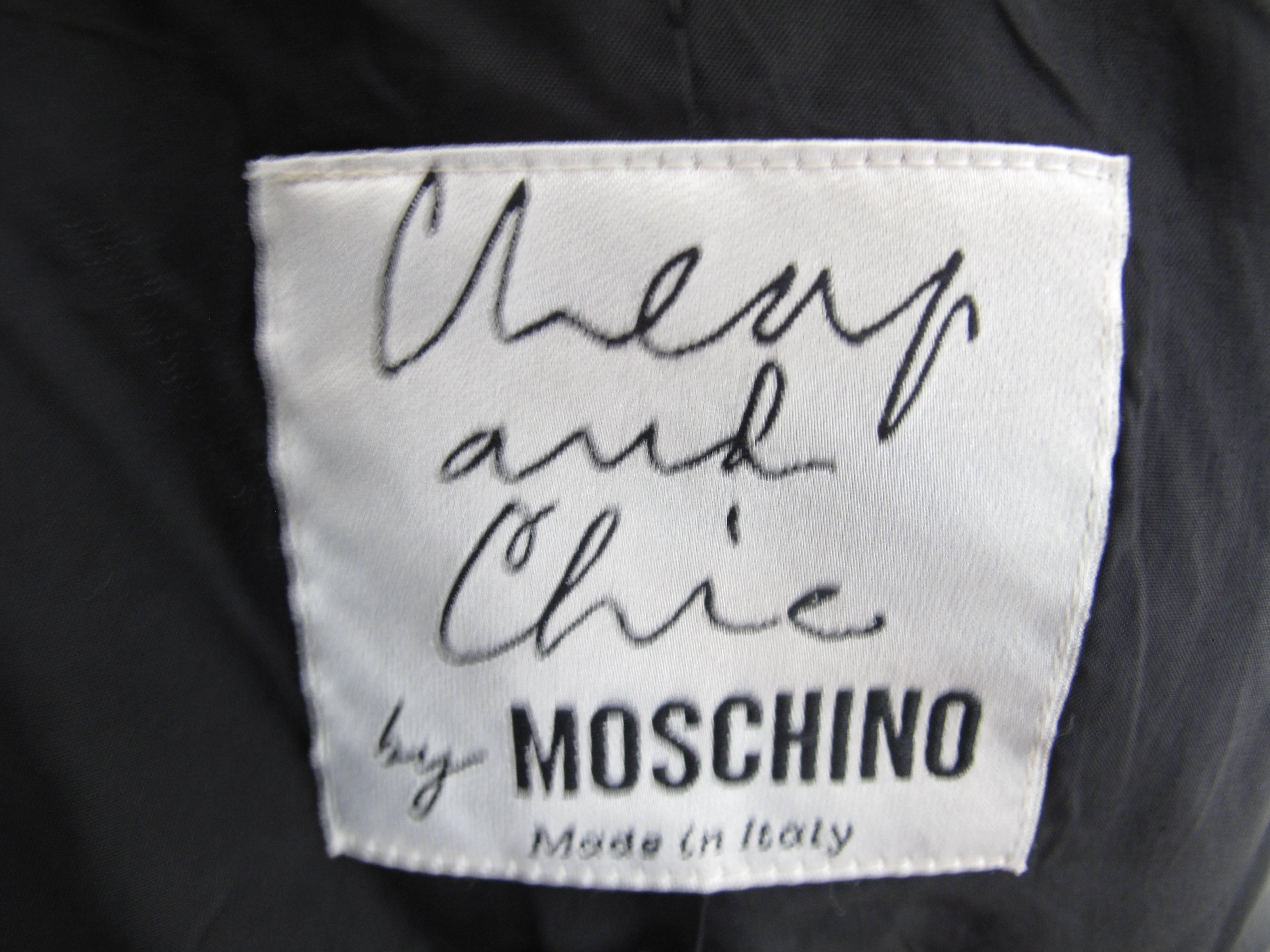 Moschino linen black motorcycle jacket with gold zippers and grosgrain ribbons.  Condition: Excellent. Size Small

We accept returns for refund, please see our terms.  We offer free ground shipping within the US
