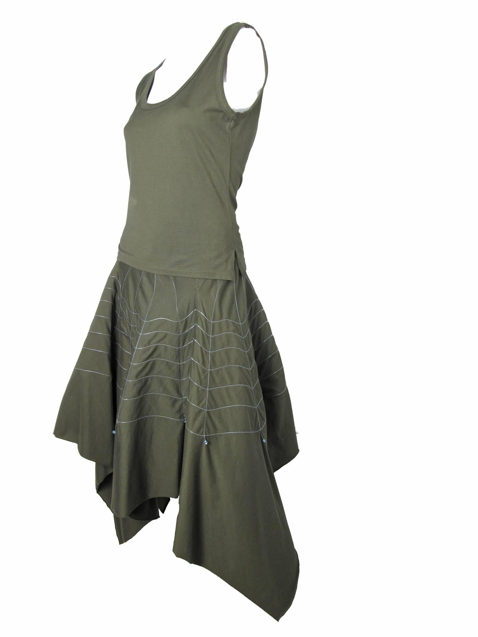 Issey Miyake Olive Green 2pc with Cobweb Design from Fishing Line.  Cotton tank top with matching skirt.  Skirt with elastic waist band and asymmetrical waist yoke. Cobweb design stitched with fishing line and crystals at ends.  Fishing line creates