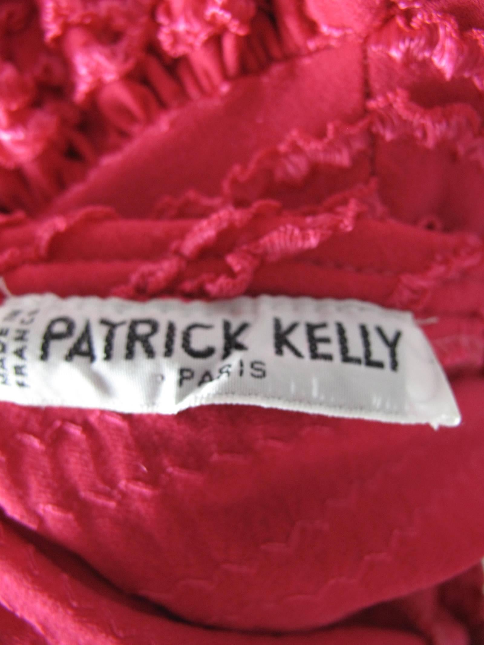 1986 hot pink Patrick Kelly dress with dropped waist and ruffles.  Fabric has elastic, can be worn off shoulders.  polamide/elastic fabric. Condition: Excellent. Size Medium 
Made in France

41" bust, 25" waist, 34" hips, 39