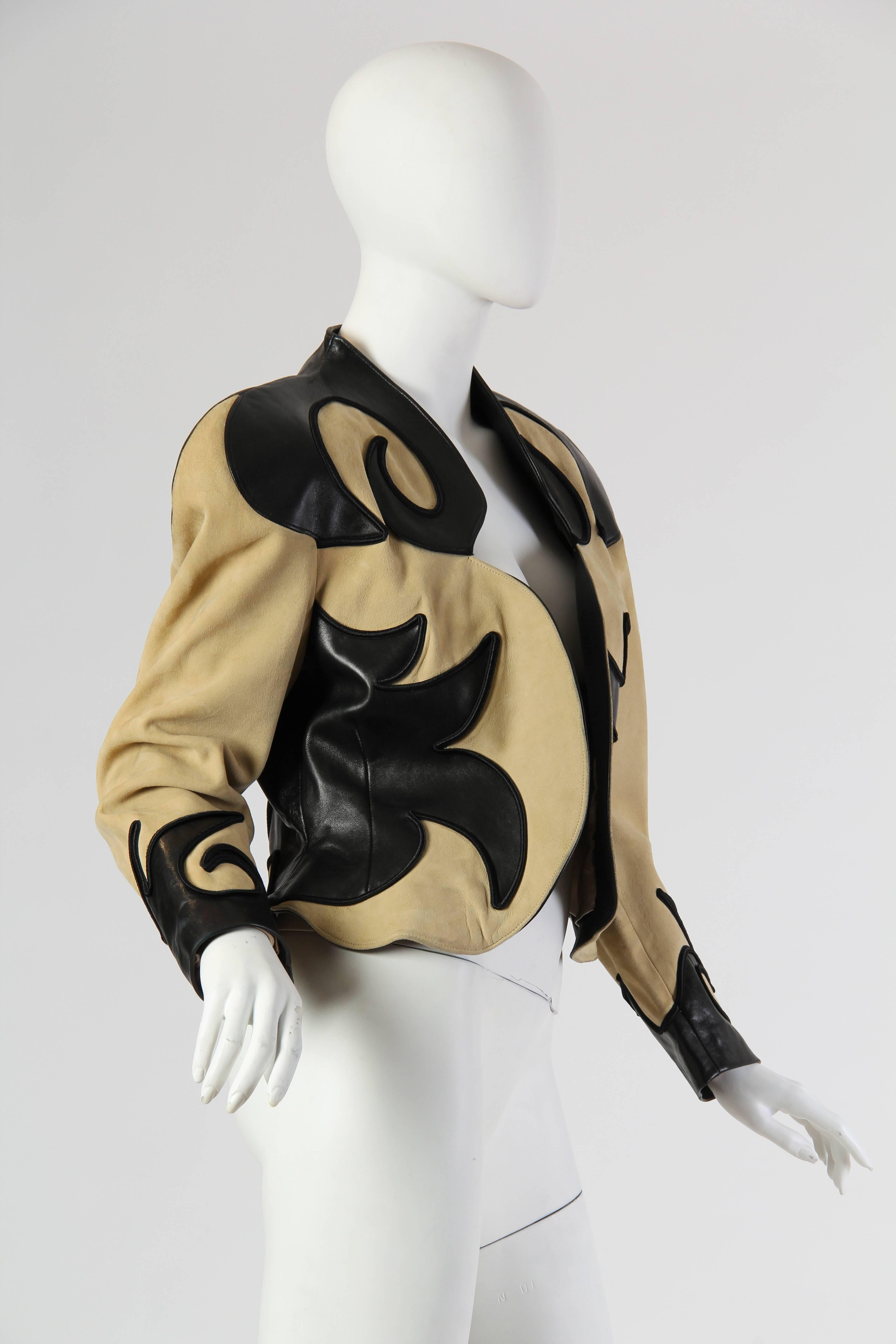 This is a stunning blazer from the 1980s by Jean Claude Jitrois. Cropped to hip-length, its slight peplum effect accents the waist and the small of the back to a highly flattering effect. The jacket is made in a soft camel tone, with incredible