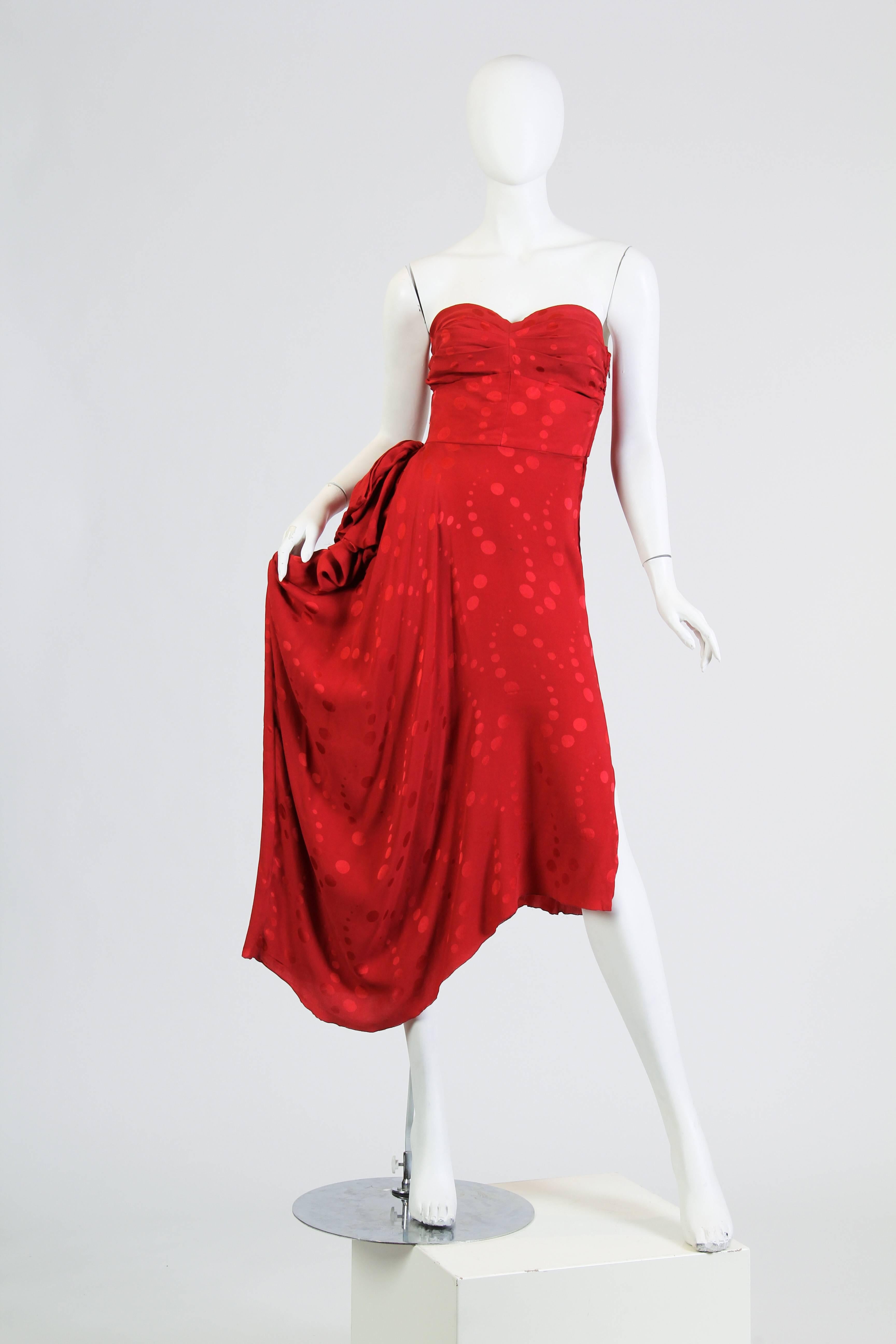 1970s Vicky Tiel Red Dress with Slit. Rare to find a 1970s Vicky Tiel dress from the late 1970s. This dress is leaning towards her more famous heavily constructed dresses of the 1980s yet has a softer semi-bias cut and draped skirt. 