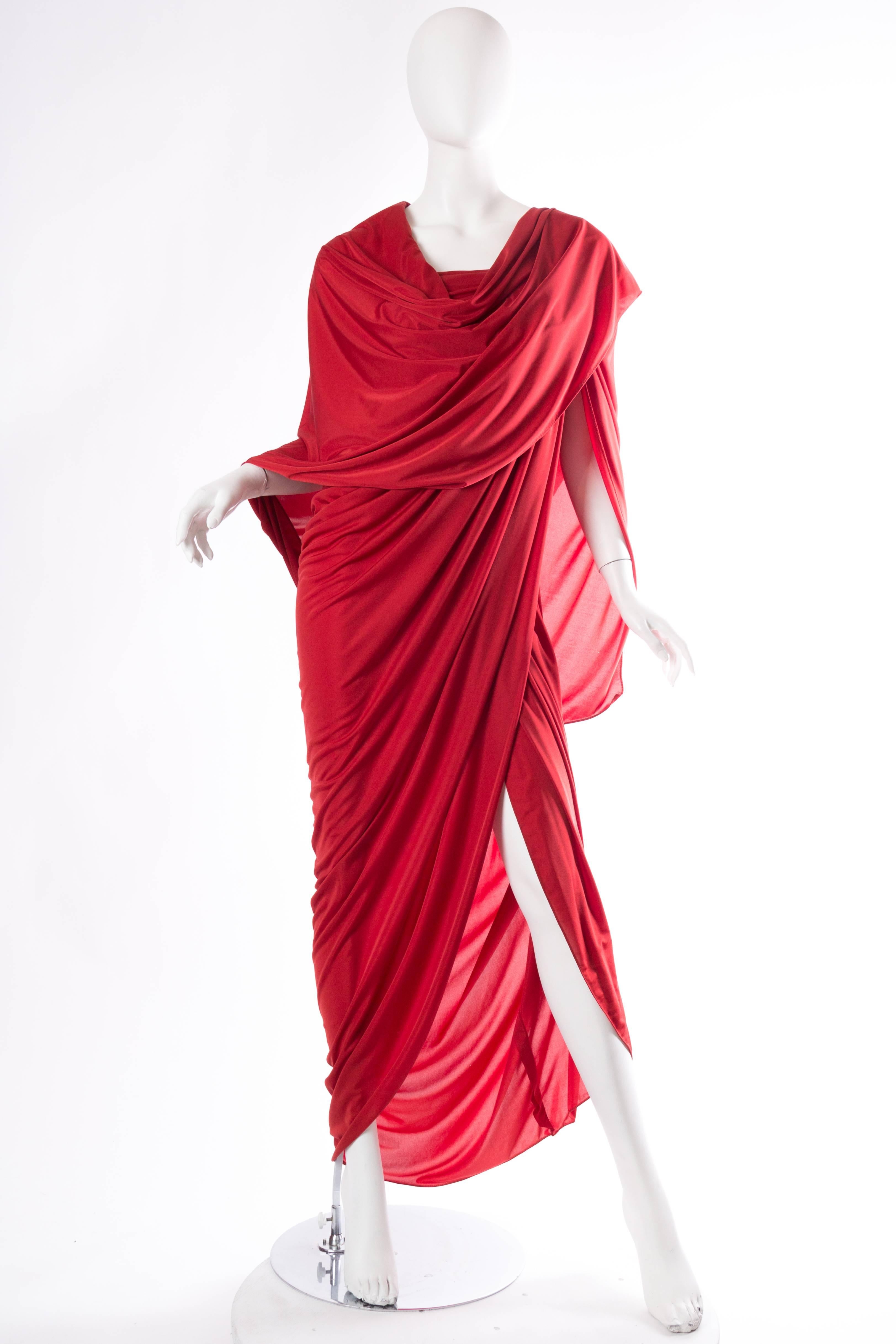Chiffon weight synthetic jersey wraps around the body in the most figure flattering of ways. The dress is cut asymmetrically with straps at one shoulder and wrapped design which allows for a very high or not so high slit. There is a fantastic shawl
