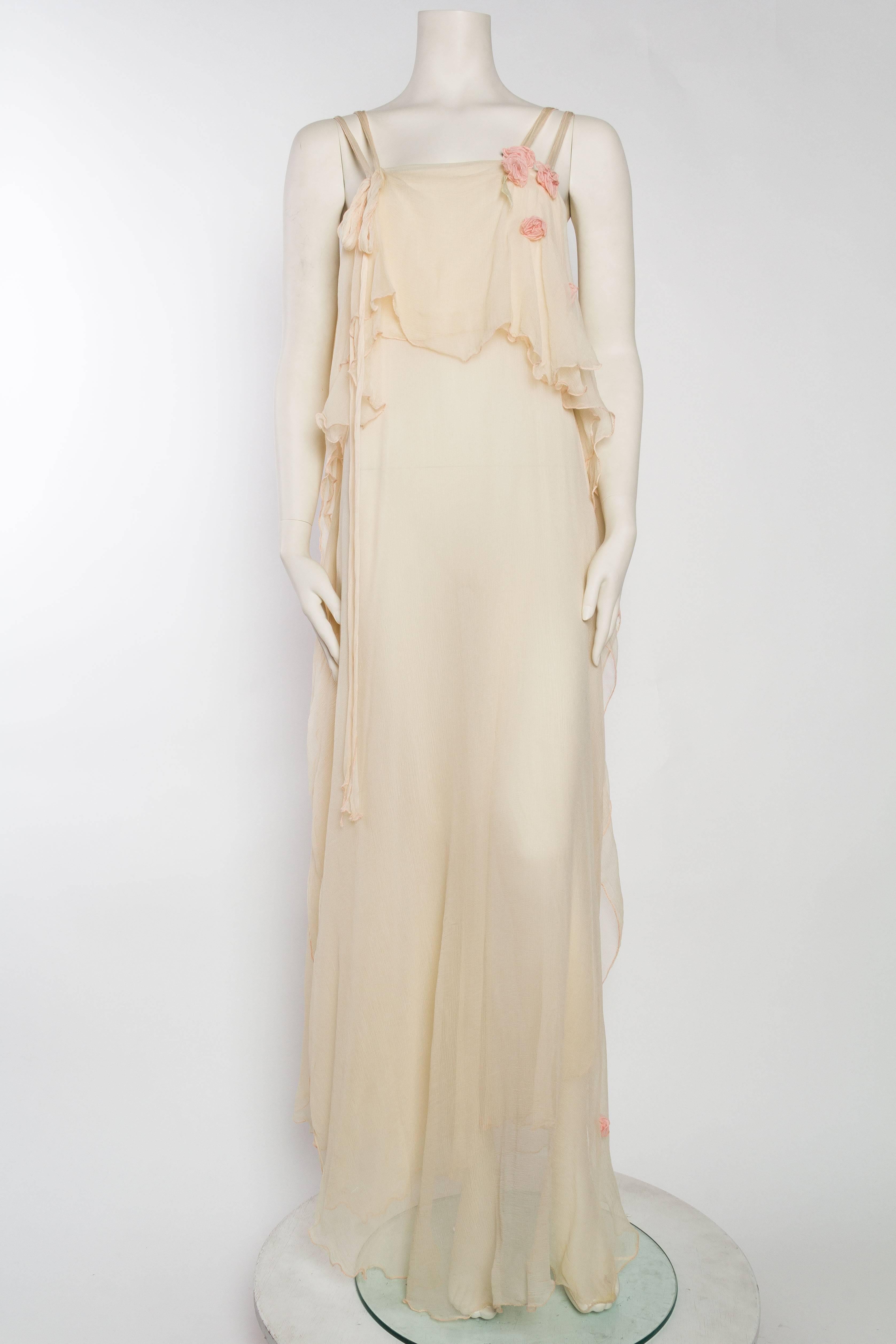 Romantic layers of chiffon from the 1970s evocative of a medieval forrest nymph. Sprinkled with pink roses and ready to dance around the garden in celebration of spring. 