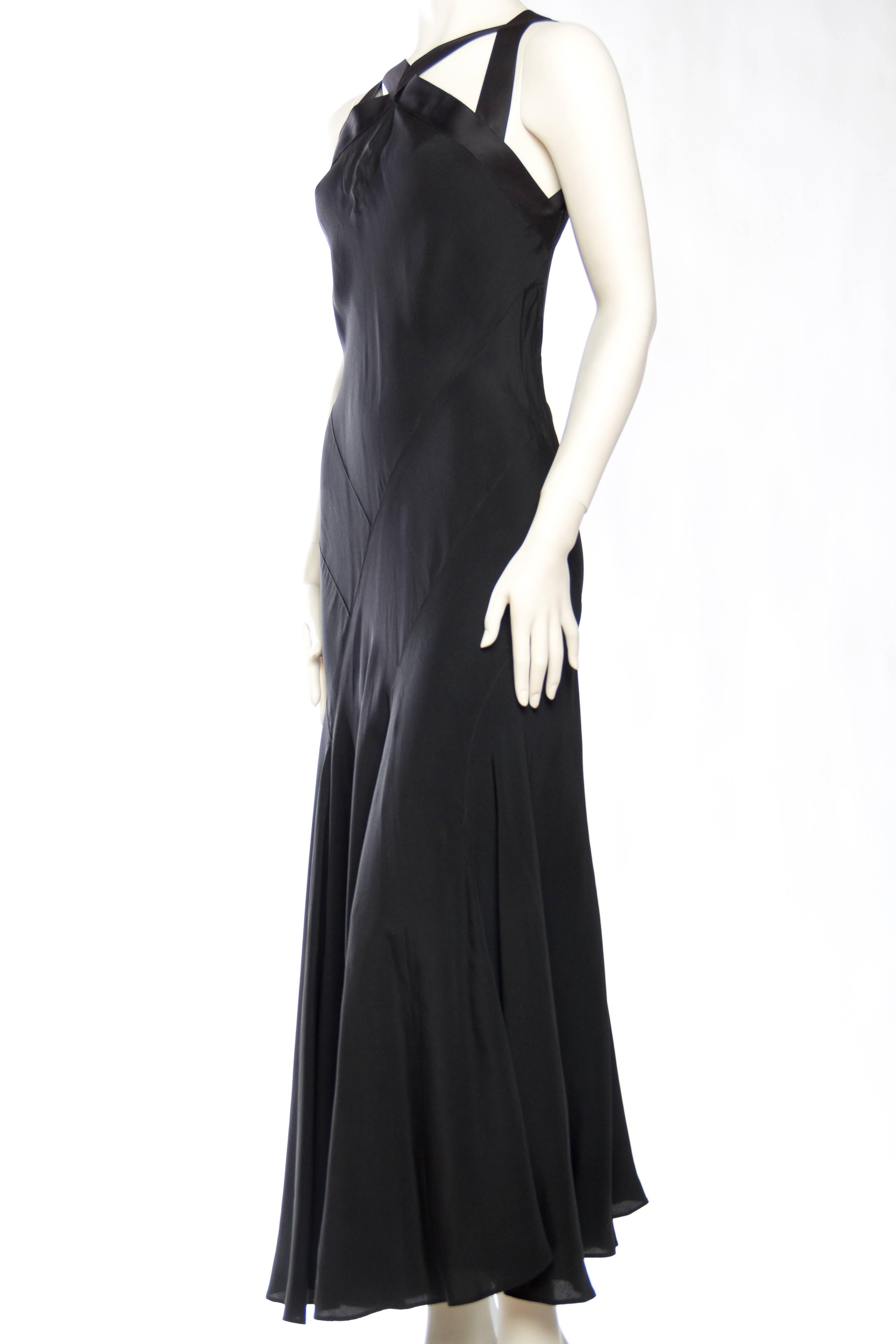 This high fashion gown from the 1930s silver screen era is a knockout. The silk has been draped on the bias and seamed up the body with a quiet asymmetry. The top of the dress has been re-built with vintage ribbon inspired off an original Lanvin
