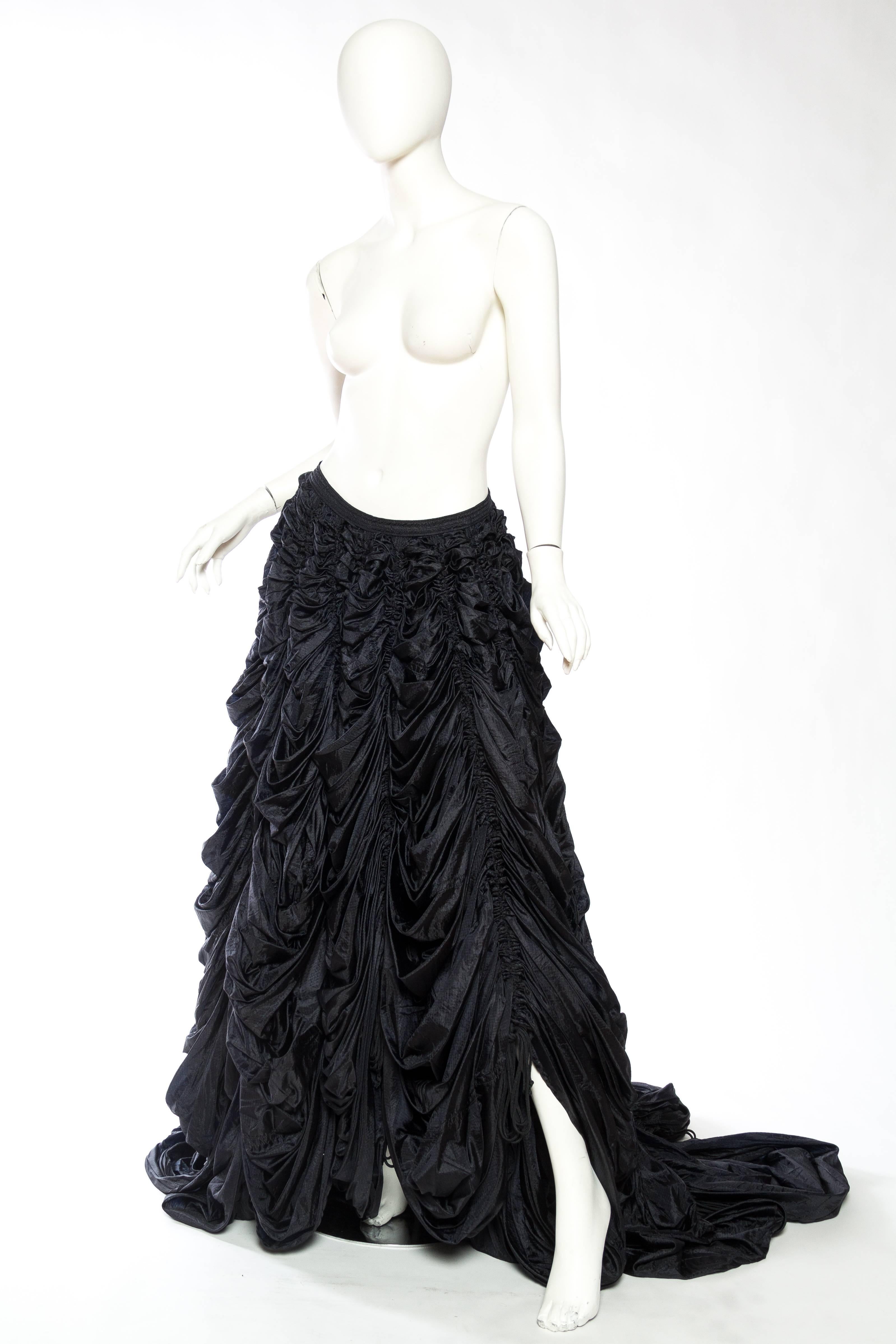 This skirt can be adjusted with the ruching to become a bubble skirt, a high-low, or fully trained red-carpet ready ball skirt. 

Please note we have a collection of rare co-ordinating parachute pieces purchased directly from Norma Kamali's archives
