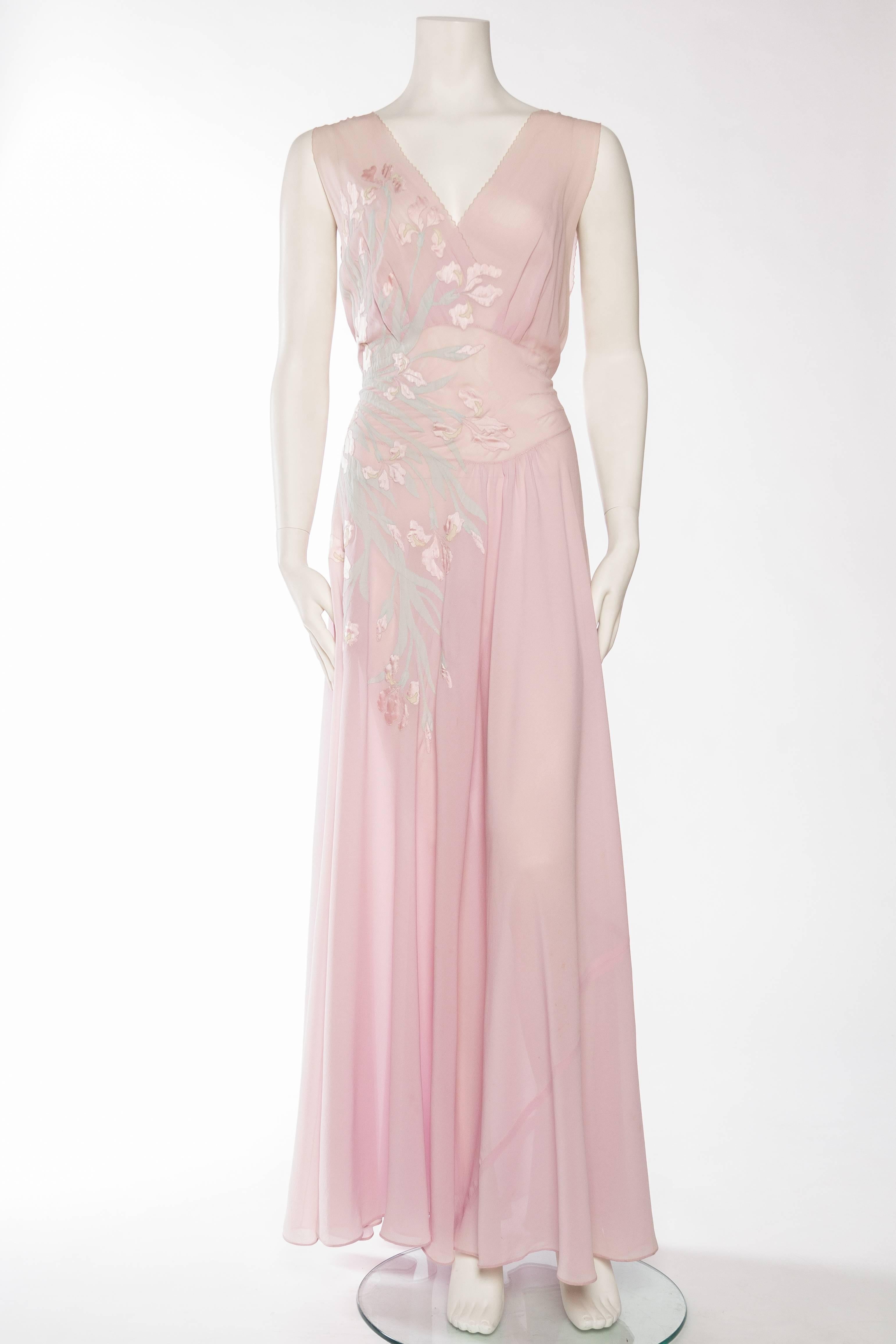 This by far is the most phenomenal negligee we have ever seen. The sheer mastery of the couture seamstress who appliquéd the delicate strips of silk chiffon and satin onto the bias cut of this piece is mind boggling. Also a rare larger size however