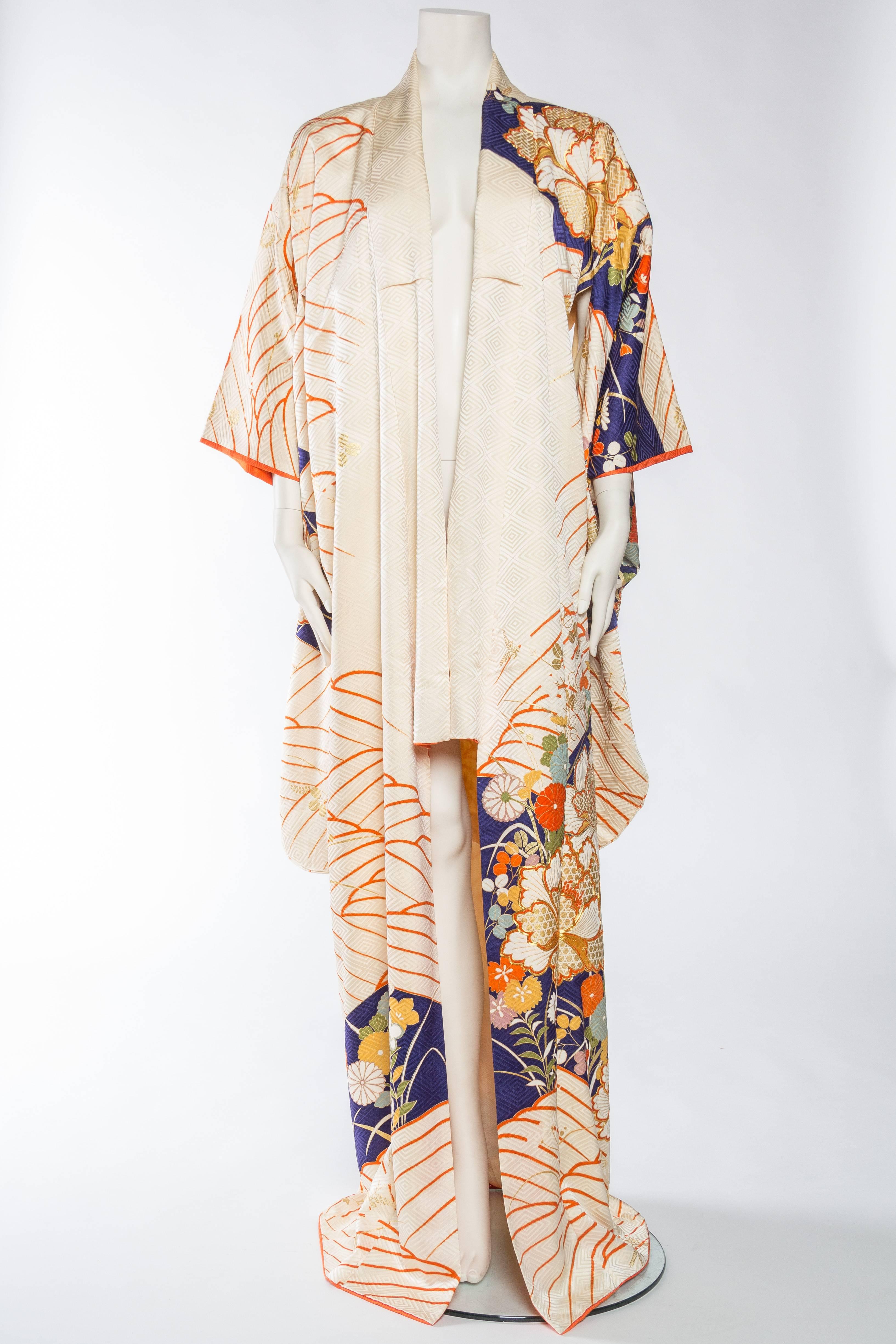 There is wonderful movement to the design of this kimono. Hand embroidered and foil printed gold flowers dance upon the orange waves with large clusters of flowers showcased here and there with even further gold embellishment. A wonderful garden on