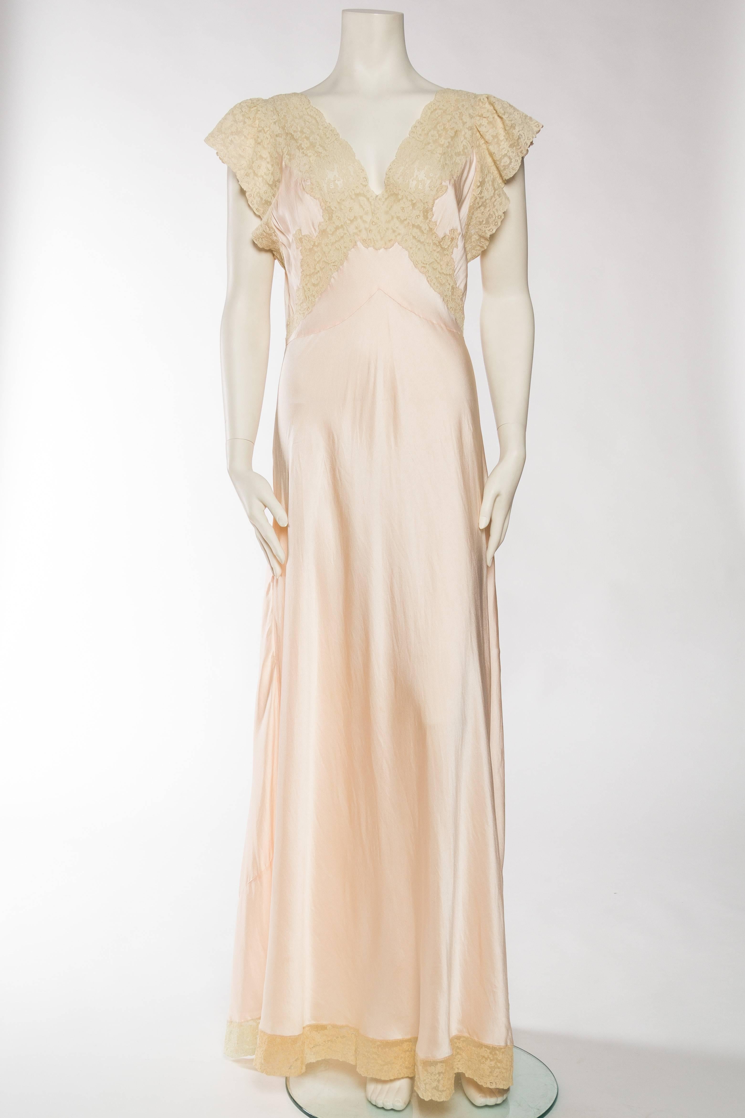 Dating from the 1930s/40s this negligee is a rare silk one, not rayon like many from the era. Most likely made in France where these superior slip dresses were made. 