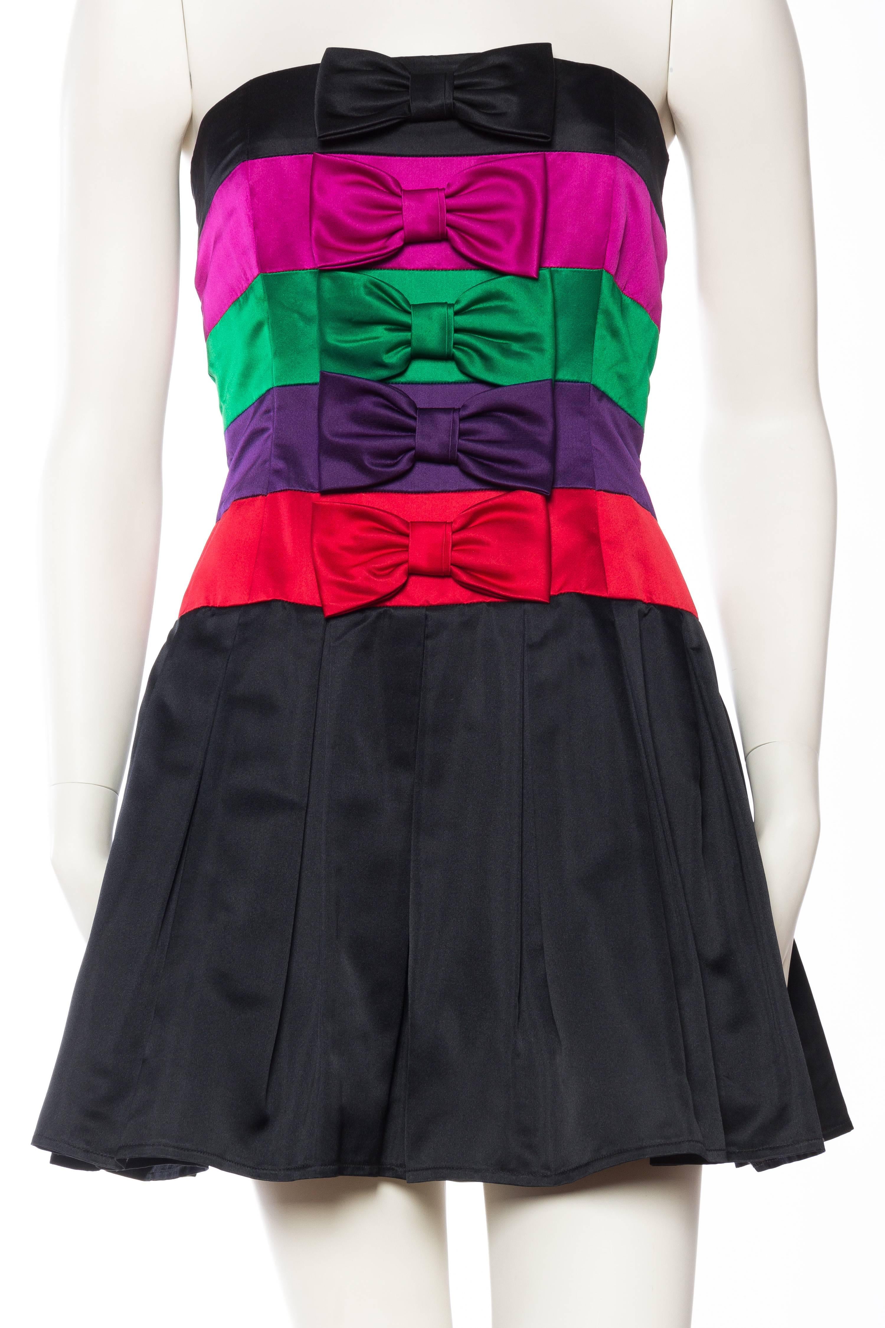 Bands of luscious duchess silk in rich jewel tones adorned with large satin bows is the principle design element to this fun little dress by French designer Albert Nipon. Fully lined in silk with a boned bodice. 