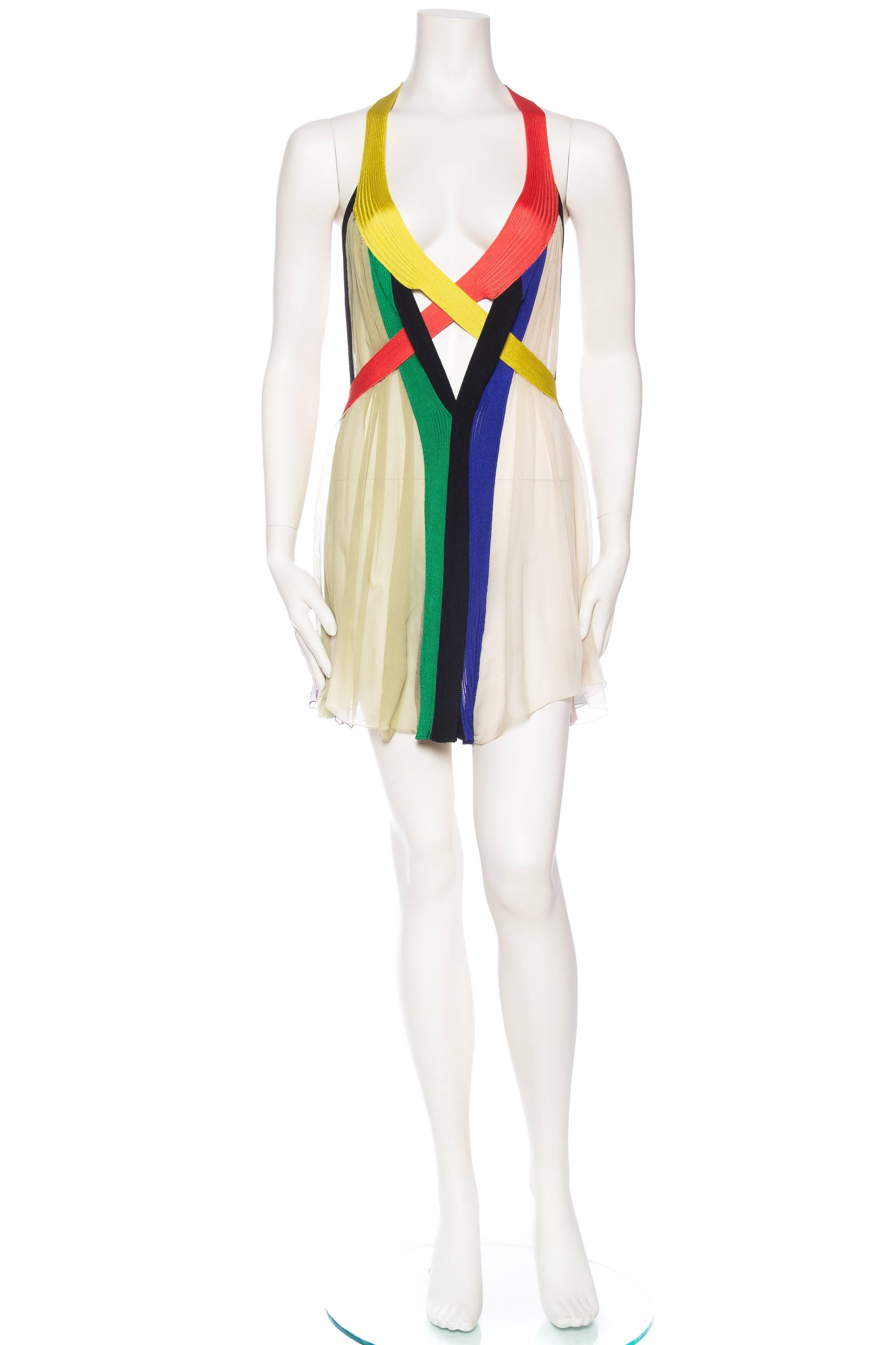 Genius, strips of soft knit and panels of silk chiffon are all Jean Paul Gaultier  has used to create this masterpiece of a dress. Most likely meant as a layering piece as it is sheer and revealing. Works great both with a bikini as well as one of