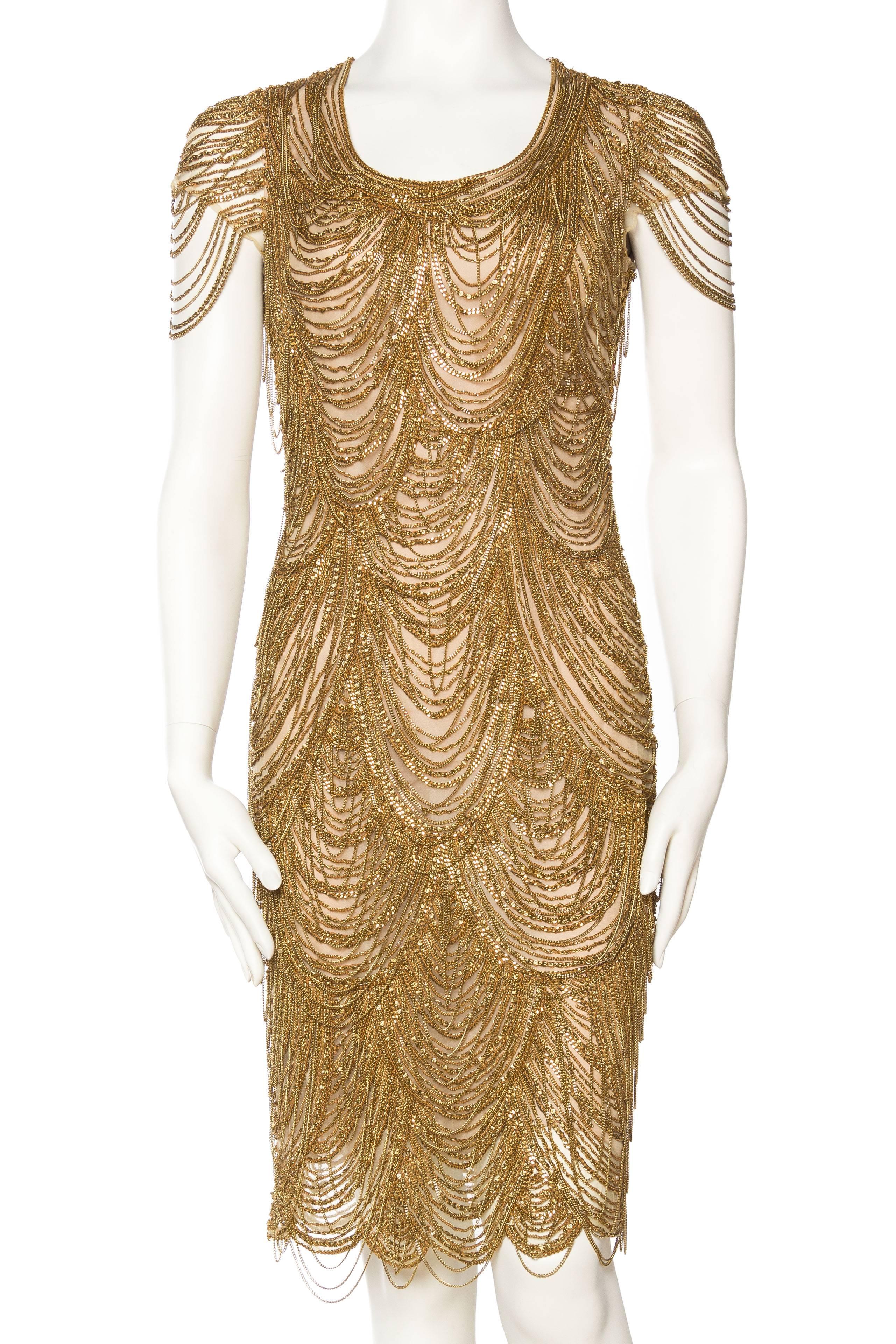 Hundreds of heavy gold chains are both sewn and draped on this dress, which takes it from classic to otherworldly. The sheer nude mesh is lined in silk. The movement of the chains and the golden sparkle of this in person is fantastic. 