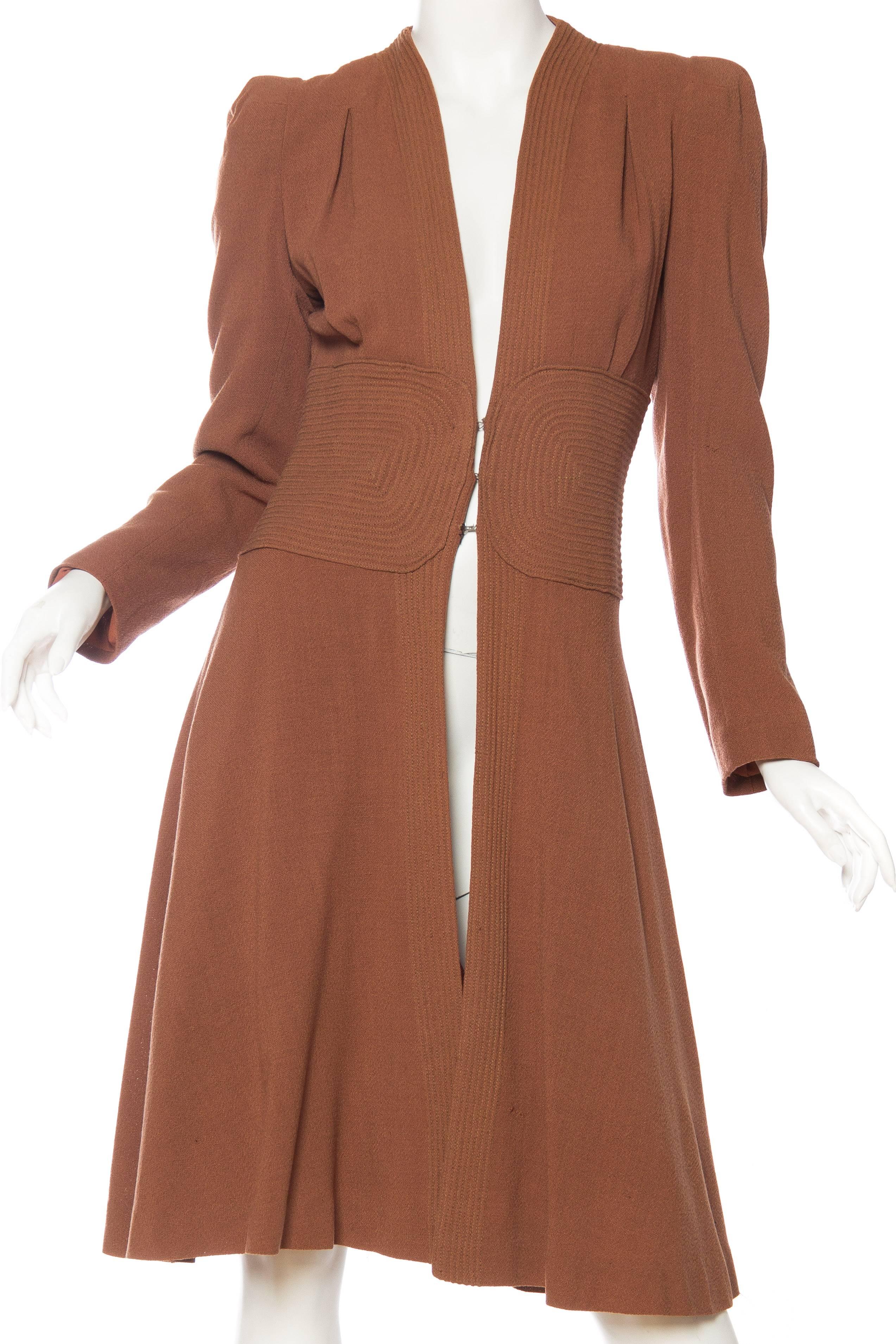 This coat dates from the late 1930s or the early 1940s. This is very much the style of piece which inspired the 1970s designers Biba and Ossie Clark. 