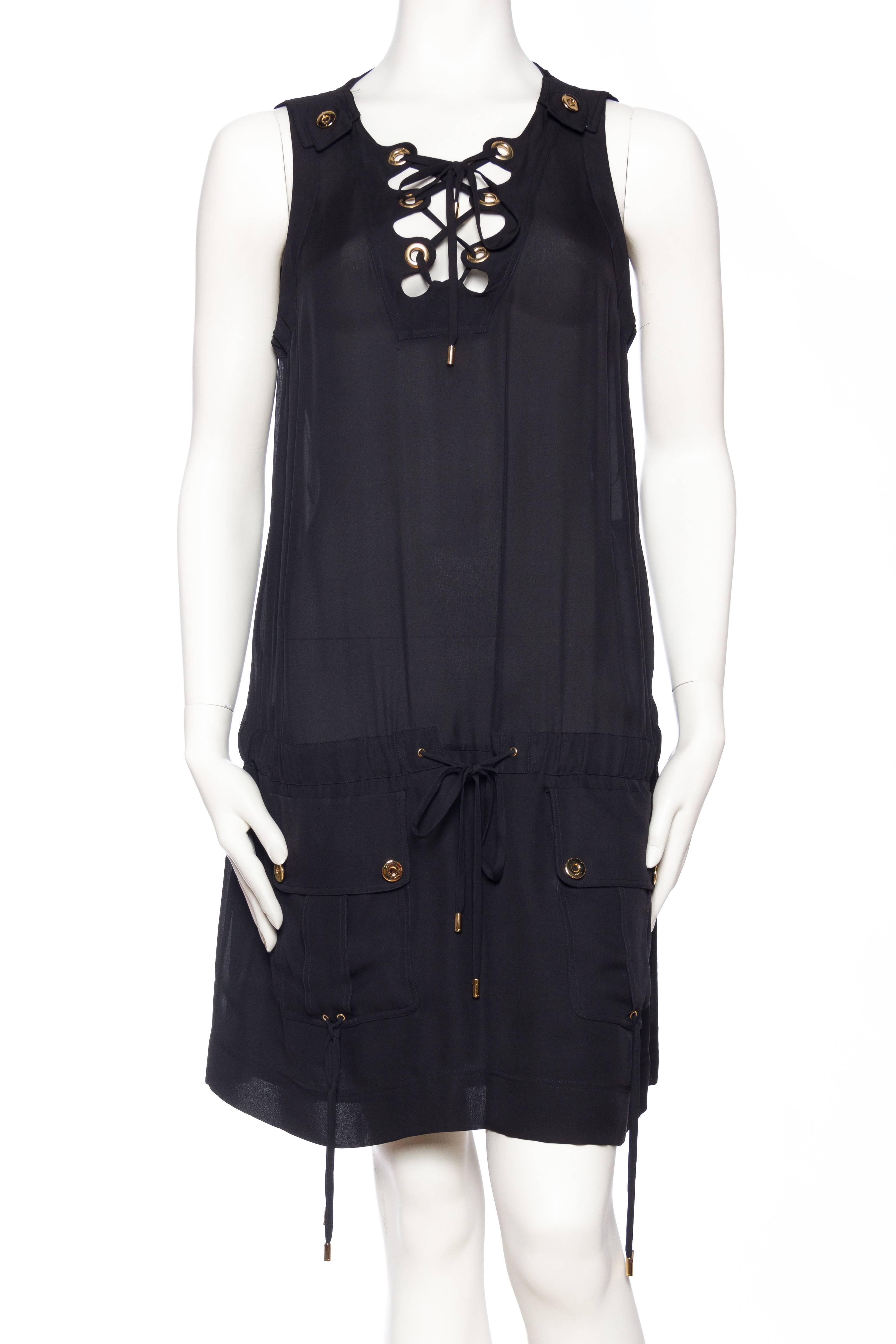 Dress is semi sheer with a laced up front and safari patch pockets. 