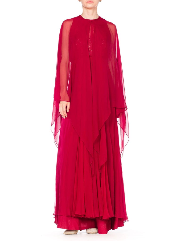 Lined in satin backed crepe for a luxurious feel, beautifully finished by hand, exceptional quality.  1970S ALFRED BOSAND Cranberry Red Beaded Silk Chiffon Demi Empire Waist Gown With Cape 