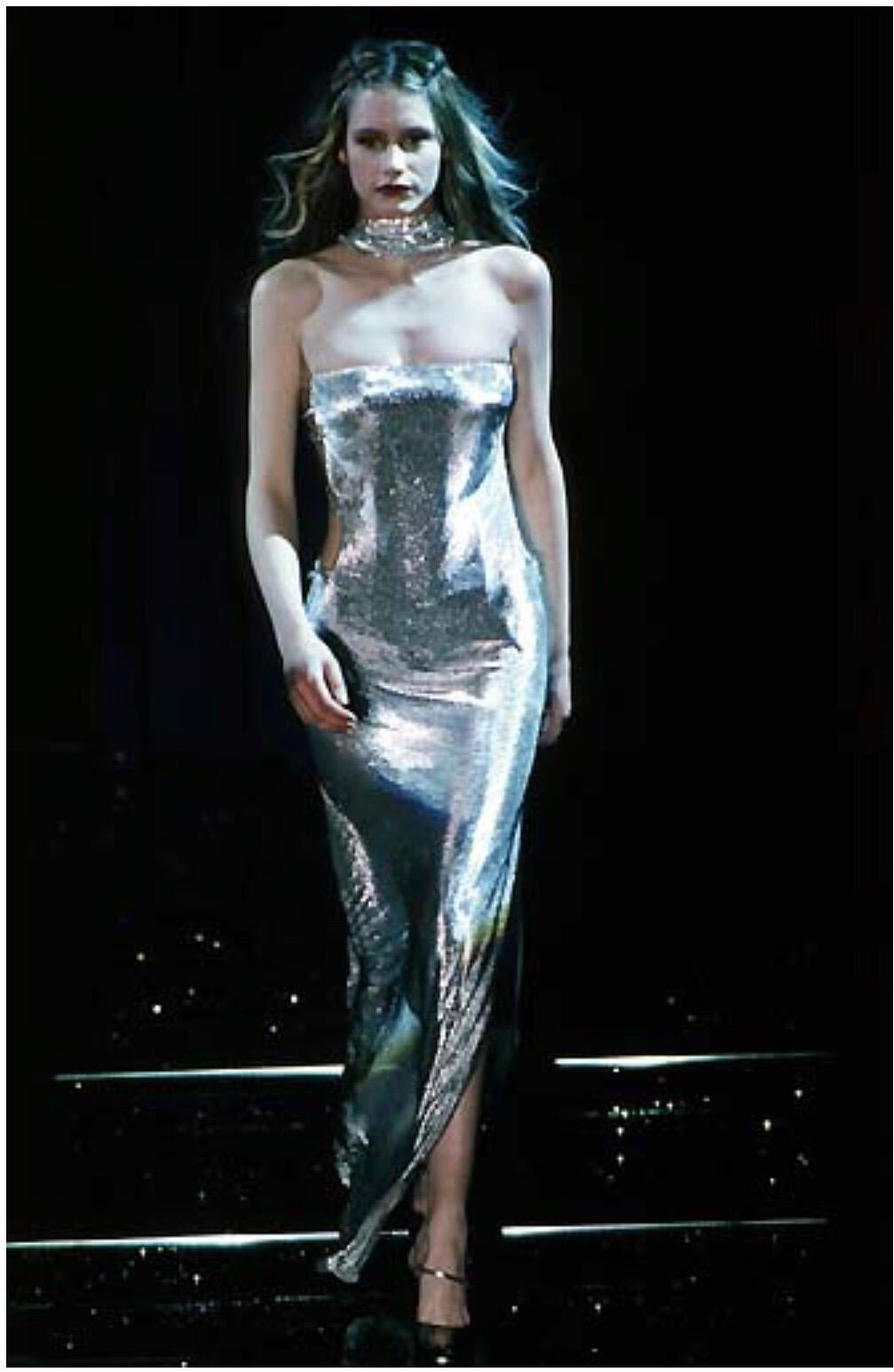 There is phenomenal internal construction in this dress which holds it to the body. The dress has an internal bodysuit on the lower half and the front of it is completely boned to keep it straight. There is one strap across the back which holds the