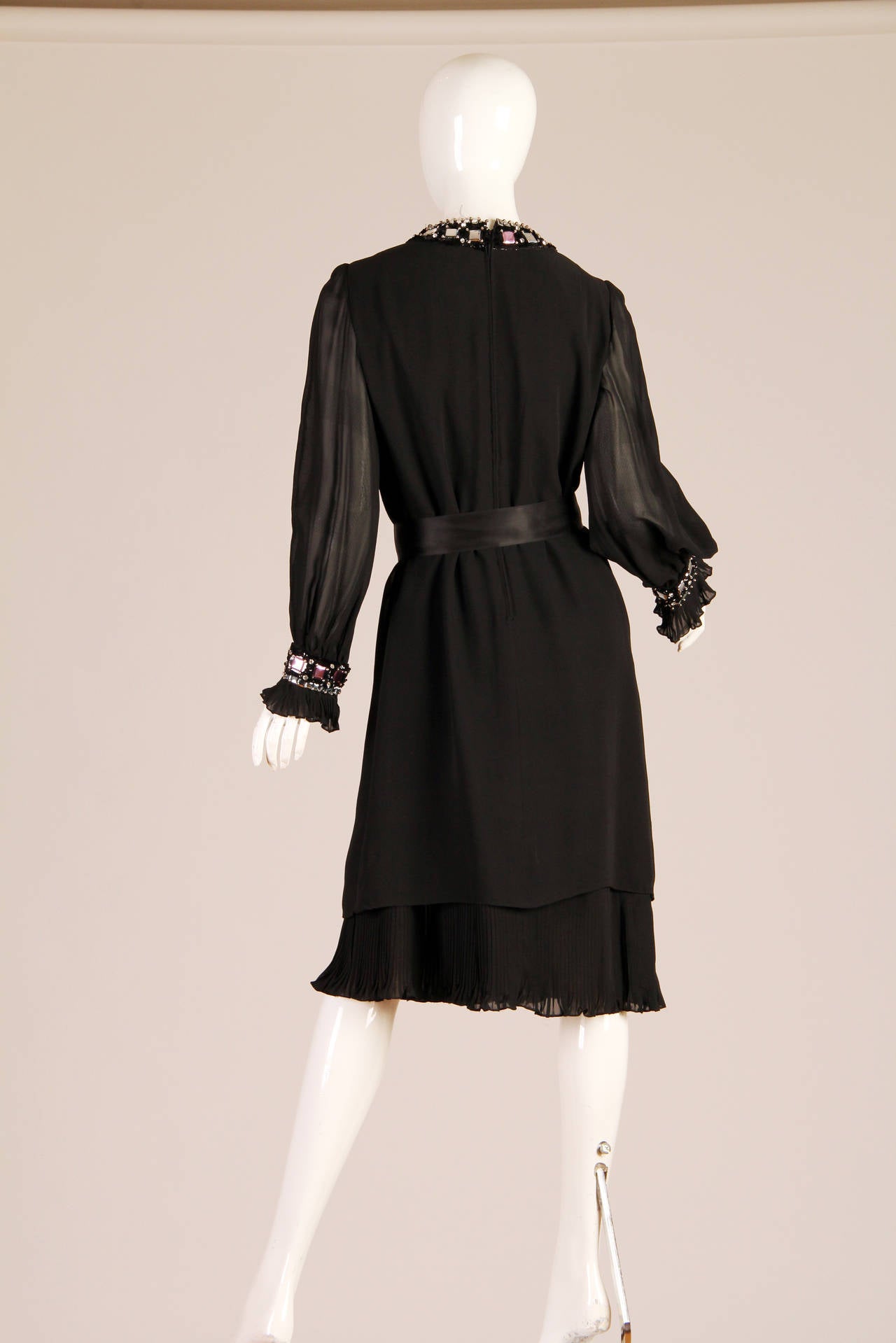 Pierre Cardin gave us this ravishing below the knee dress in the 1960s. The gauzy silk keeps this little black dress curious and sexy. We love how the sheerness of the fabric becomes apparent with your movement! The beaded detail around a neckline