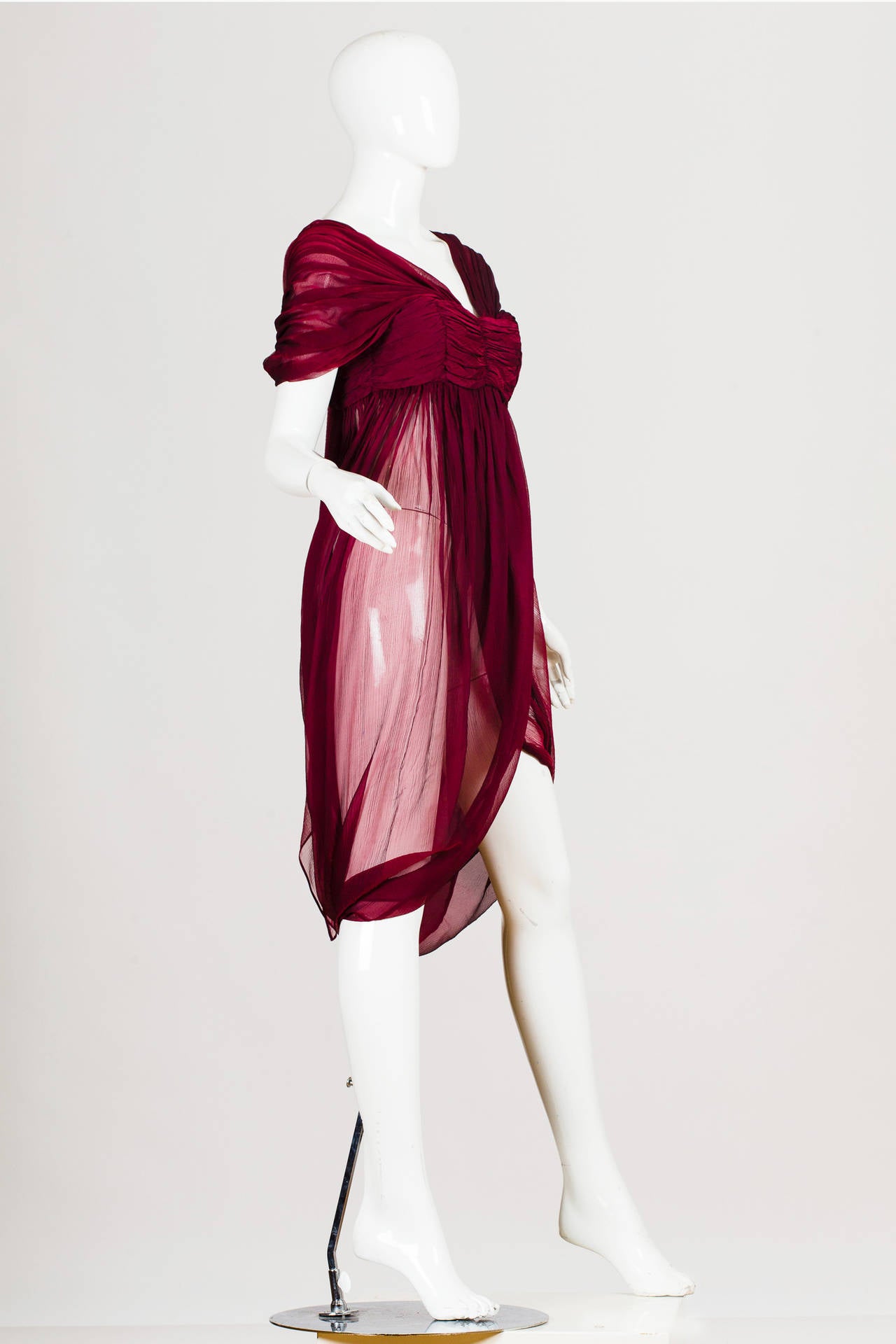 This piece is from Alexander McQueen's Autumn/Winter 08-09 collection, inspired from his recent trip to India. This deep ruby red dominated the collection paired only with black, white, and gold. His inspirational muse, in his fantasy, was a girl
