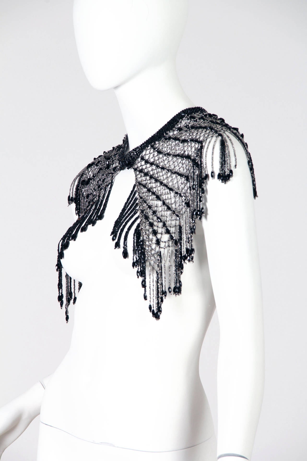 From the 19th century Guilded Age ready for the 21st Century.  This handmade beaded net collar was meant to be worn then just as one would today, to add a drape of richness and sparkle to any ensemble. The beadwork is constructed very strong and