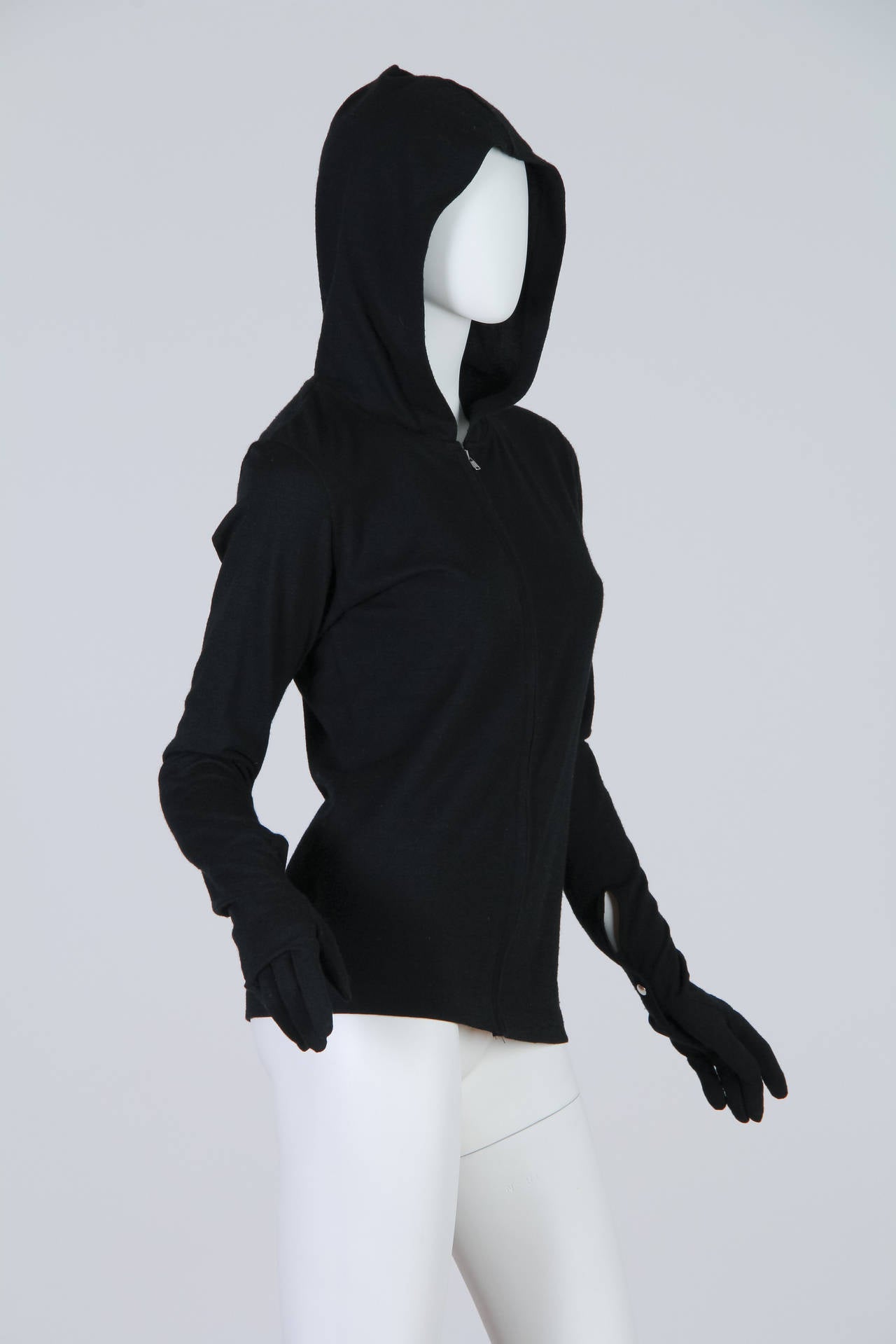Killer cool in one easy piece from Comme des Garcons. A staple for any collector. The gloves are attached to the ends of the sleeves for a seamless look.