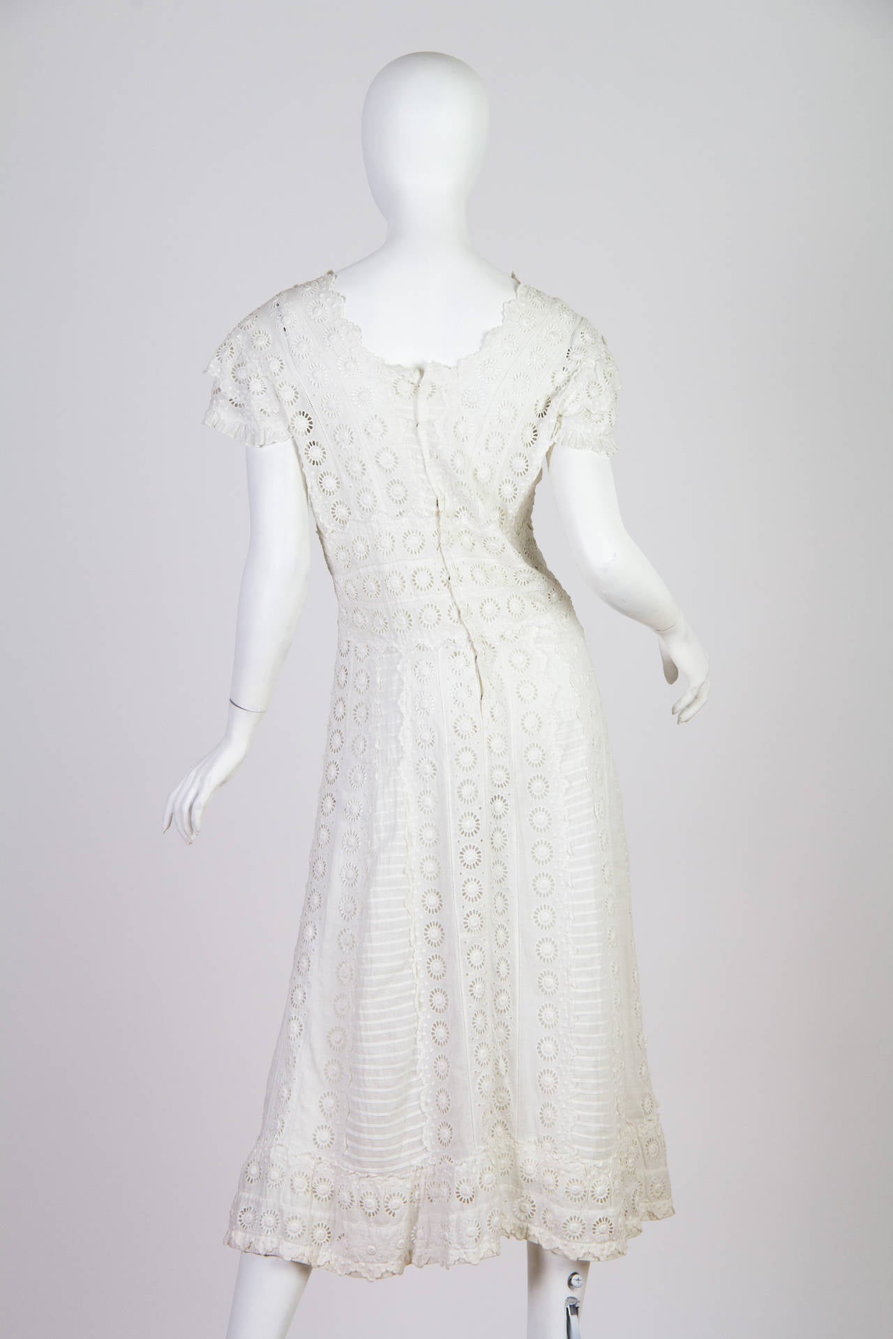 This dress dates to the early teens before the war. The length might baffle some however it was a fashion in the day to have tiered layers of dresses. The petticoat, most likely a victim of the 1960s, was possibly the-dyed by a hippy as was the