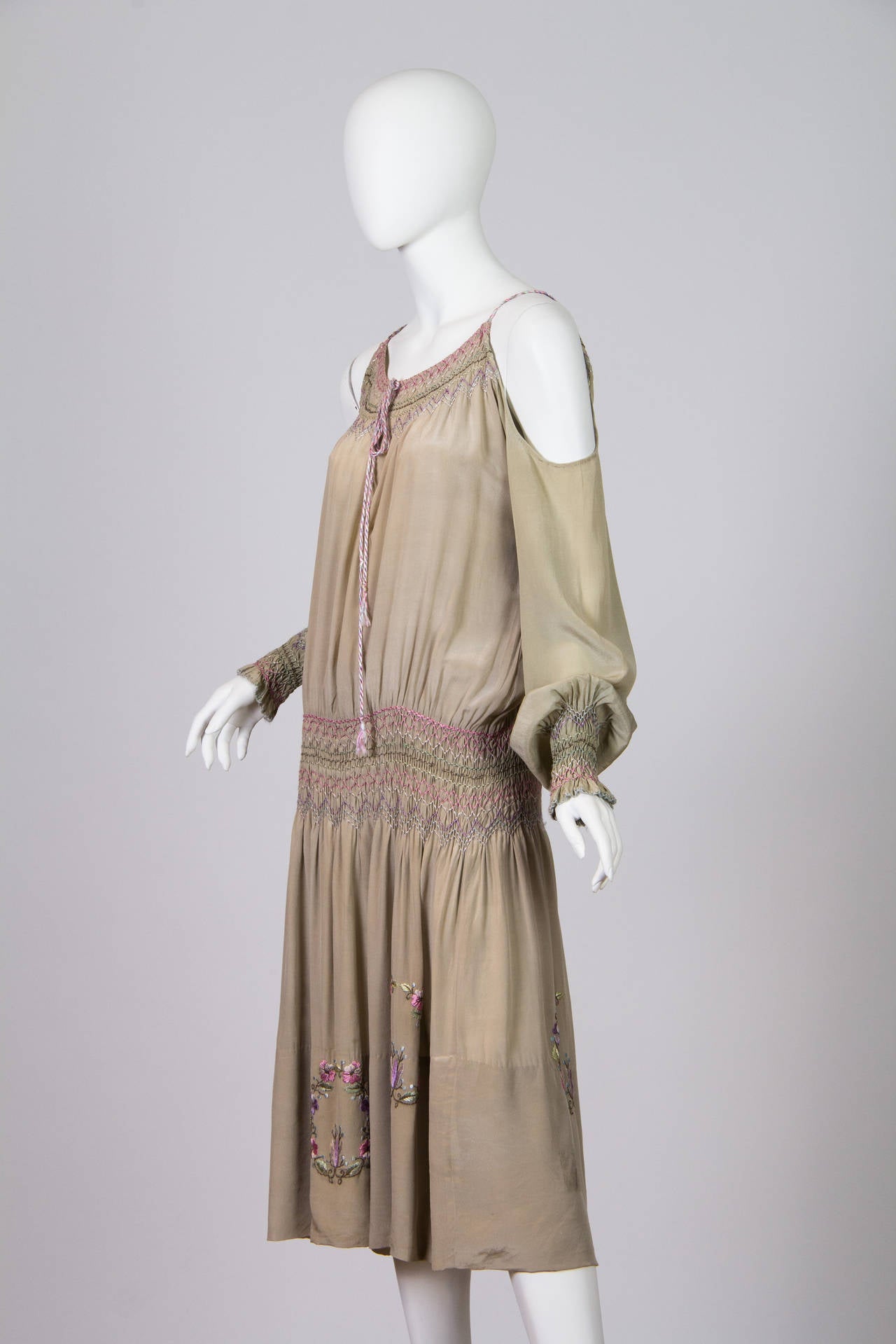 Beauty never knew such a lover. This dress dates to the early to mid 1920s. Russian peasant dresses and embroidery became a huge western trend once Chanel gave them her approval. Here this dress has all the features one looks for in one of these